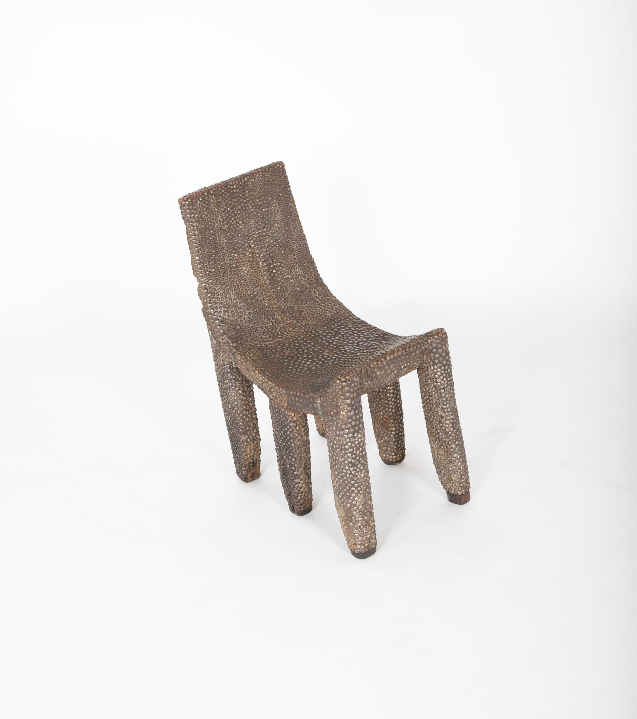 Late 19th century African Ngombe studded chair from the area of Gabon & Zaire. Previously property of Merton D. Simpson Gallery.