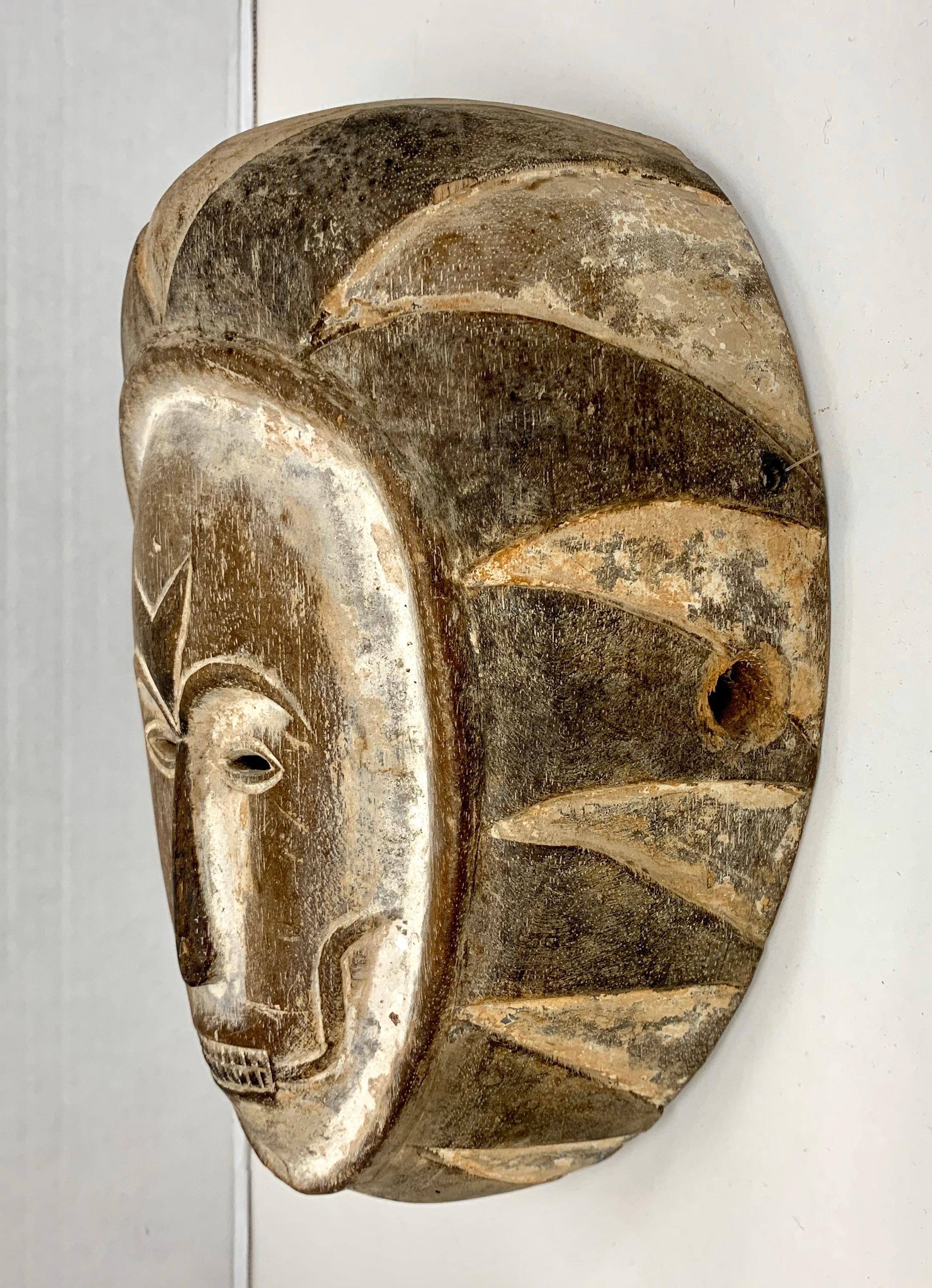 Carved African secret society mask from Eket Nigeria worn by a high initiate during mystical ceremonies. Masks such as these were used by members of the ‘Ekpo’ and ‘Ekong’ societies of the Eket for dances during harvest festivals.