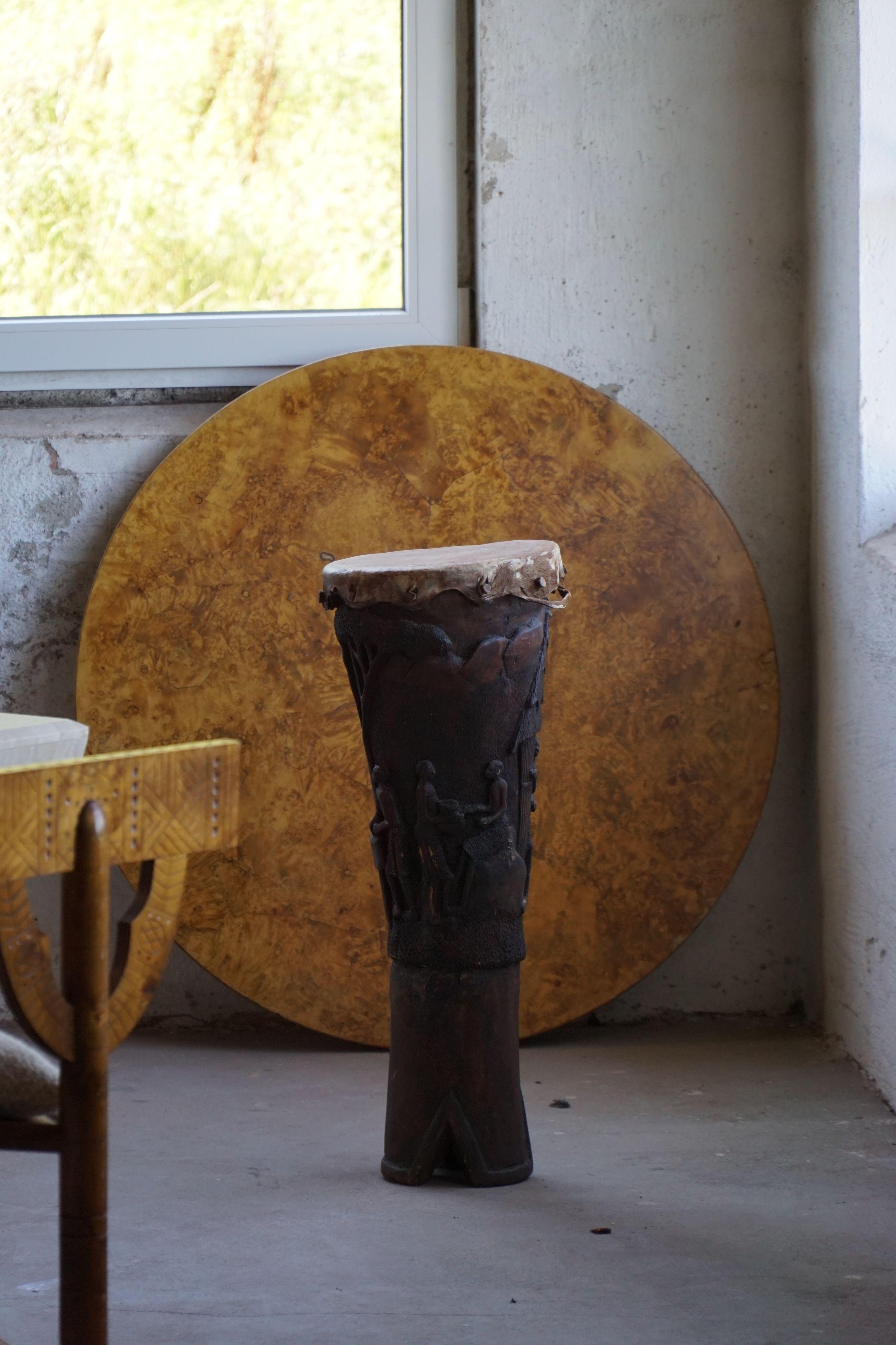 An organic, hand-carved wooden drum from West Africa, dating to the 1950–1960s. Crafted from solid wood, this piece carries both sculptural and functional qualities, blurring the line between instrument and decorative object. The surface is richly