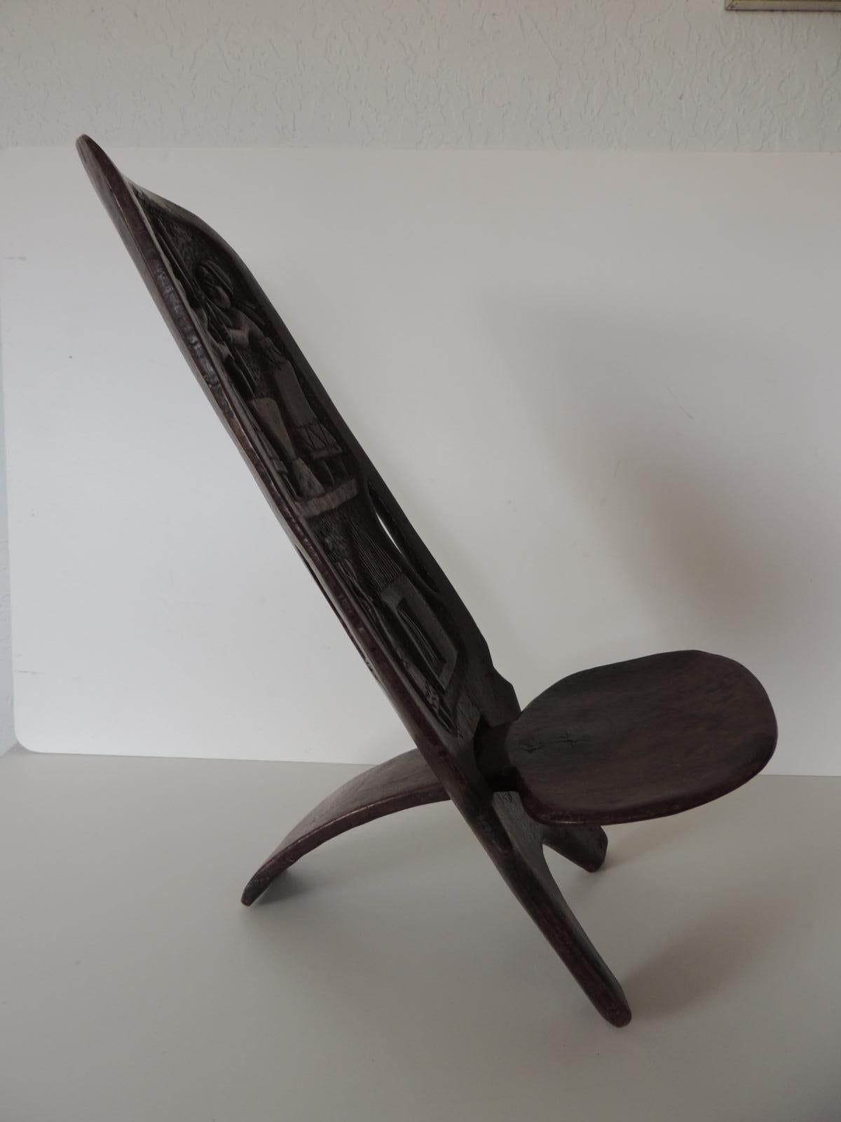 African palaver child's folding chair.
Hand carved chair depicting women at work in the back.
Rounded seat.
Size: 21