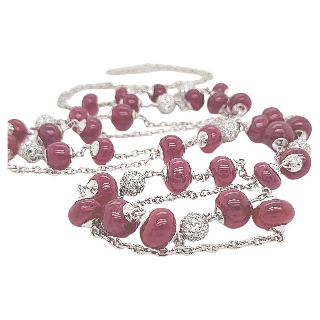 African Ruby Bead Necklace in 18k Gold Chain

Crafted with meticulous precision, this 98-mm necklace is a vision of refined luxury. 

Adorning its length are an astounding 3.31 carats of dazzling diamonds, they are a testament to the highest