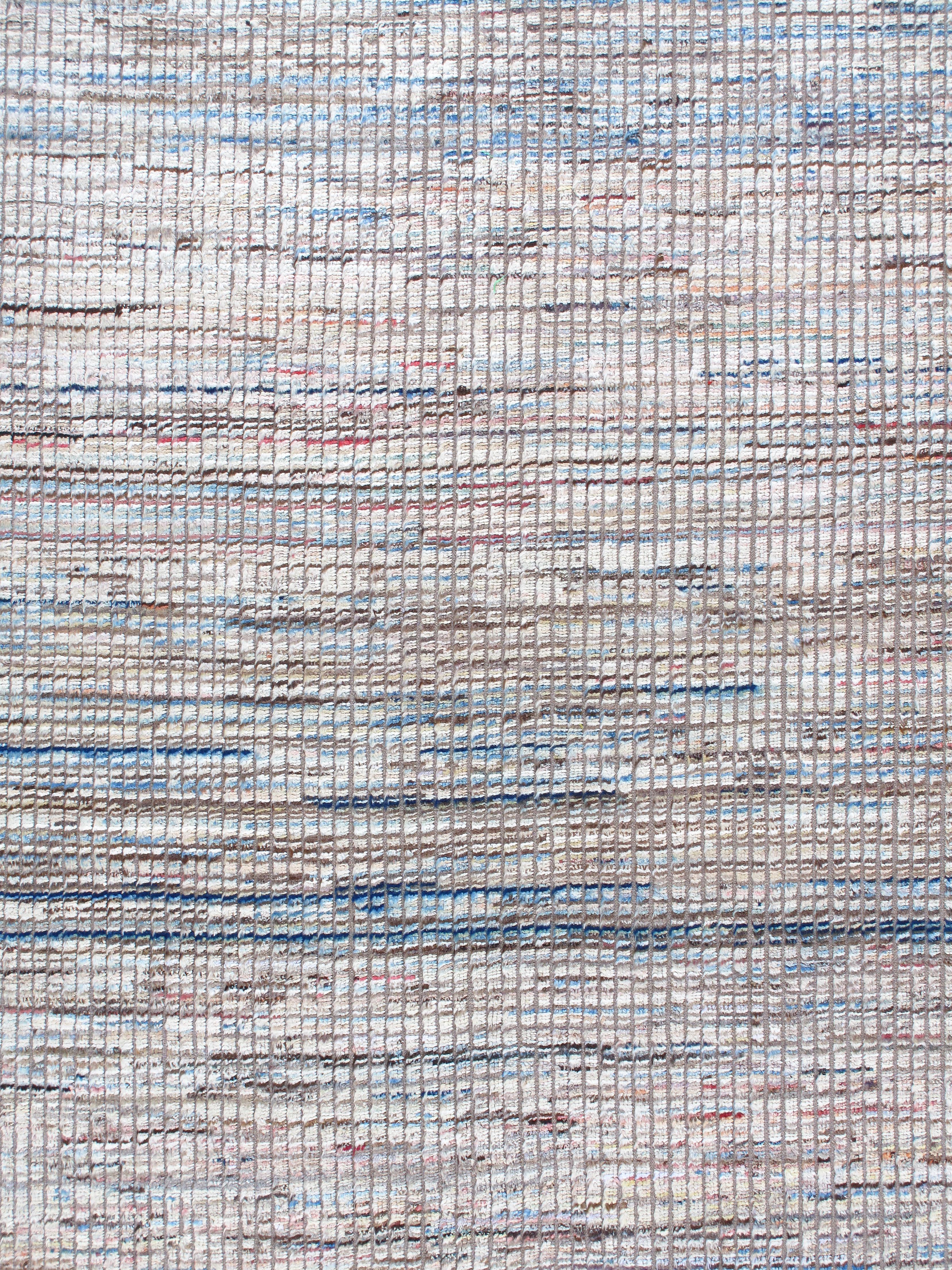Our African rug is hand-knotted and made from the finest, hand-carded, hand-spun, naturally dyed wool. With a background of neutral tones, this rug is brought to life with its subtle notes of blues, reds and pinks. Custom sizes and colors available.