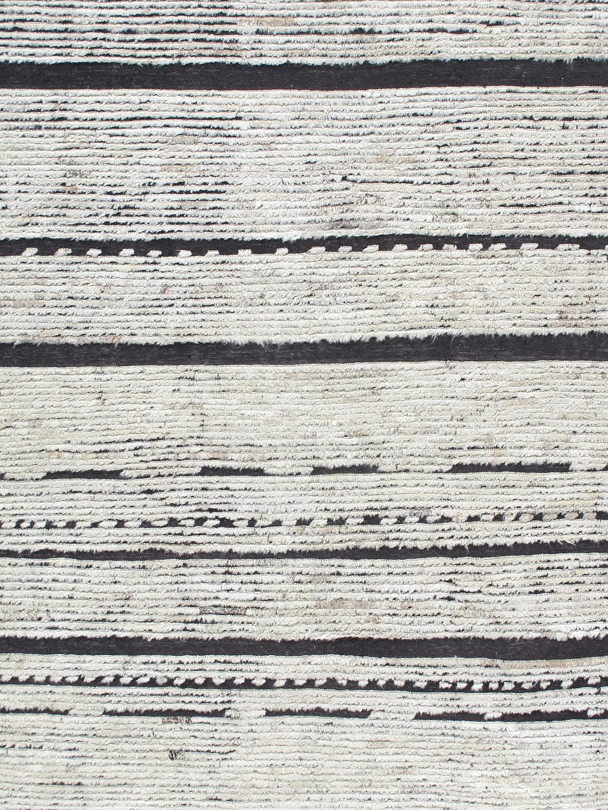 Our African rug is handknotted from the finest, hand-spun, naturally dyed wool. The black and beige modern design is both contemporary and traditional making it extremely versatile. Custom sizes and colors available upon request.