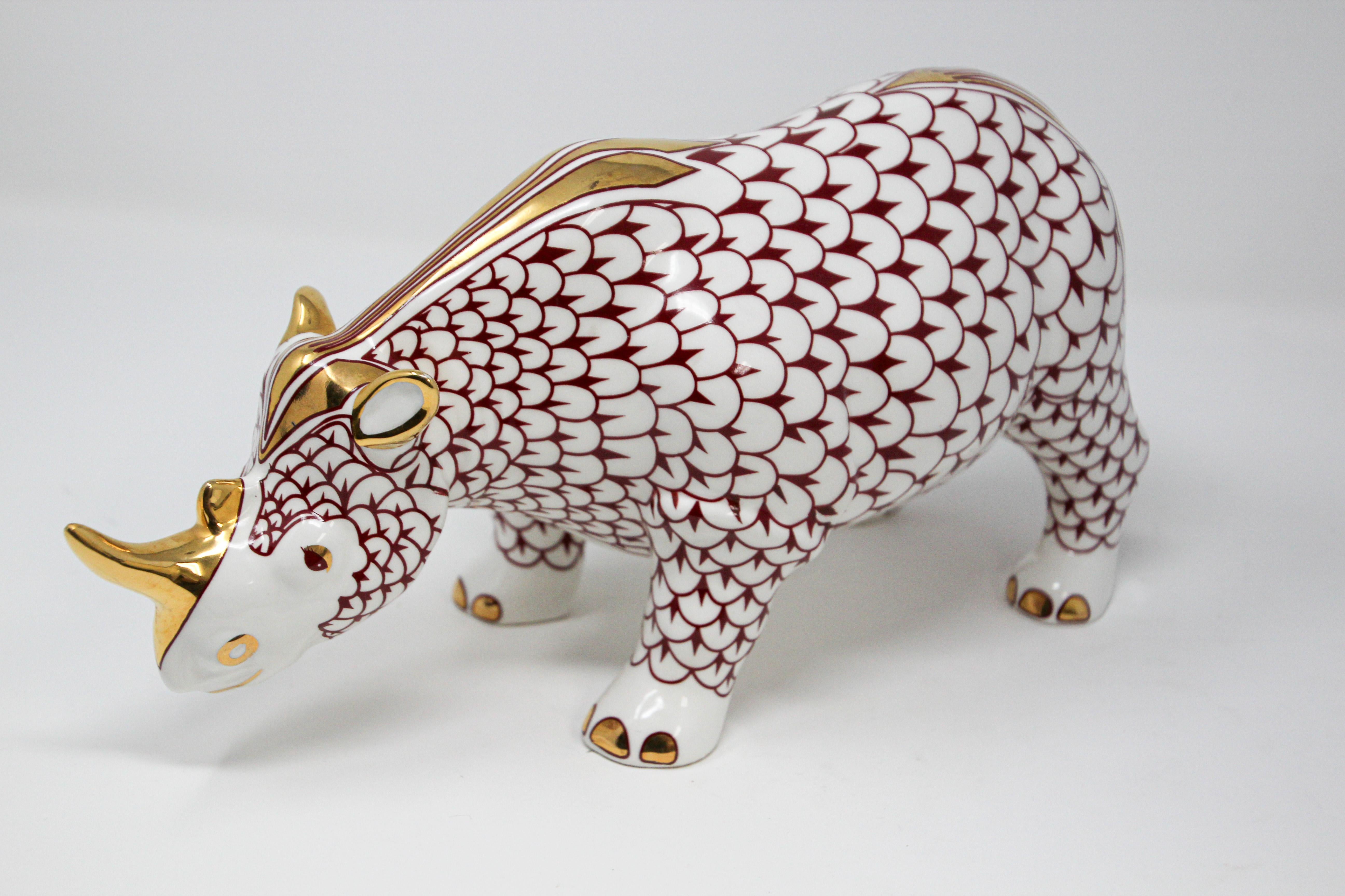 African Safari figural decorative porcelain Rhinoceros in Herend style.
Porcelain handmade and hand painted with rich shades of burgundy fishnet with 24-karat gold.
The Rhino is an elegant way to adorn your home with the spirit and image of the