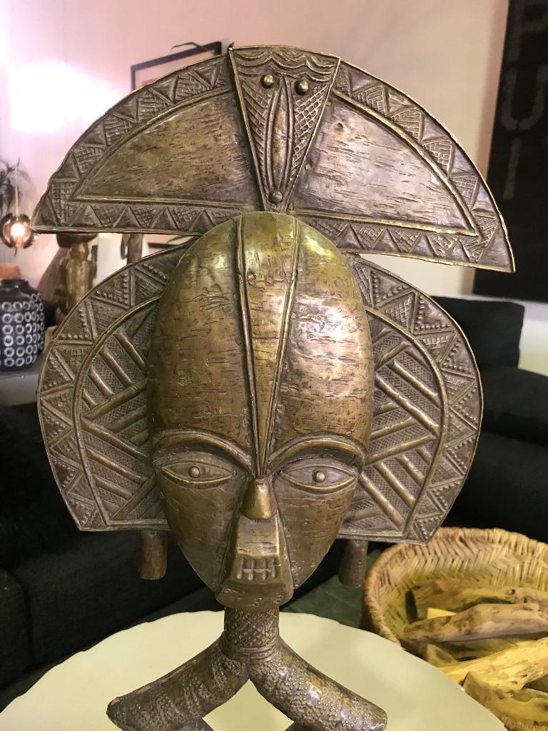A wonderfully made piece by the Kota (or Bakota) tribe who are located in the northeastern region of Gabon. This figure, which is a Obamba style reliquary figure, is made of hammered brass (often taken from imported European dishes) and wood.