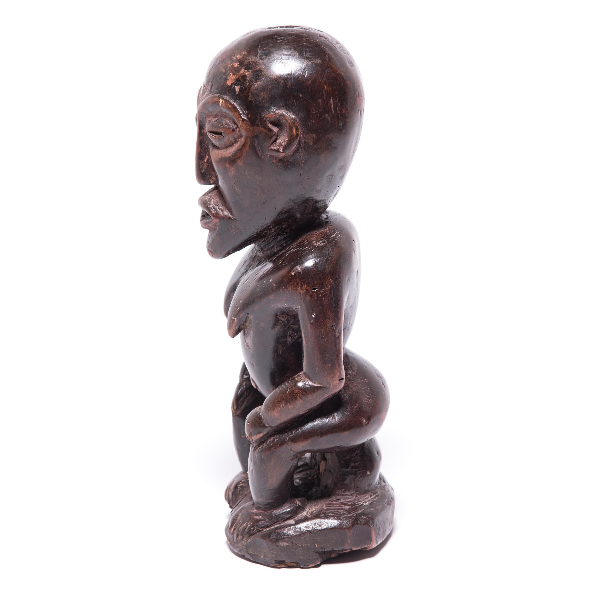 Artisans from the Luba tribe were renowned for the organic flow of their carving style. This example clearly shows the smooth transition from aspect to aspect, maintaining a singular sheen and surface. The slight tilt of the head combines with the