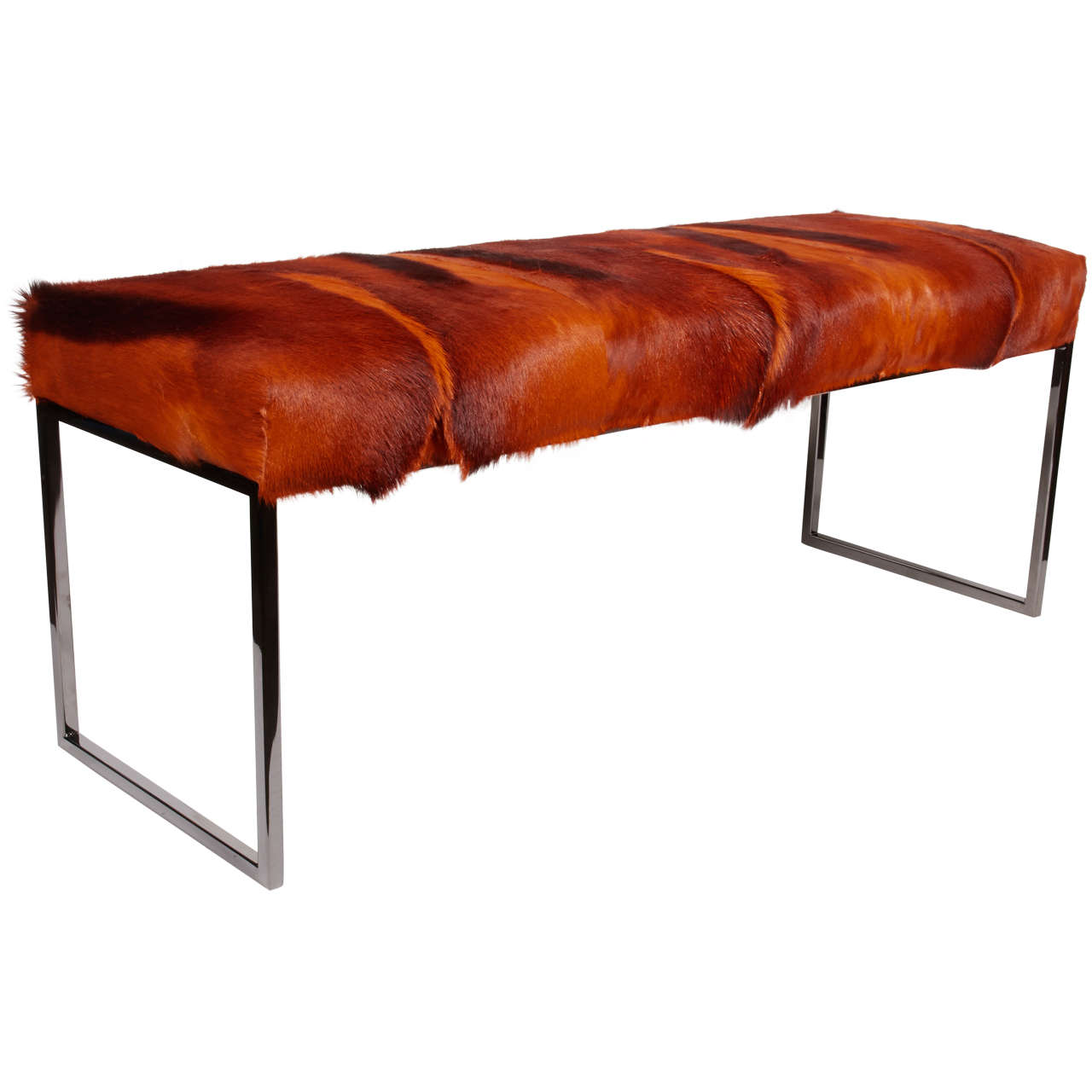 Exotic African springbok bench in hues of burnt orange. Mid-Century Modern design with streamline base in black chrome metal. Hand-dyed and comprised of several hides featuring multiple spine details. Excellent accent piece for any room.