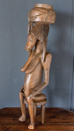 African Statue Depicting a Female Figure in Carved Wood
