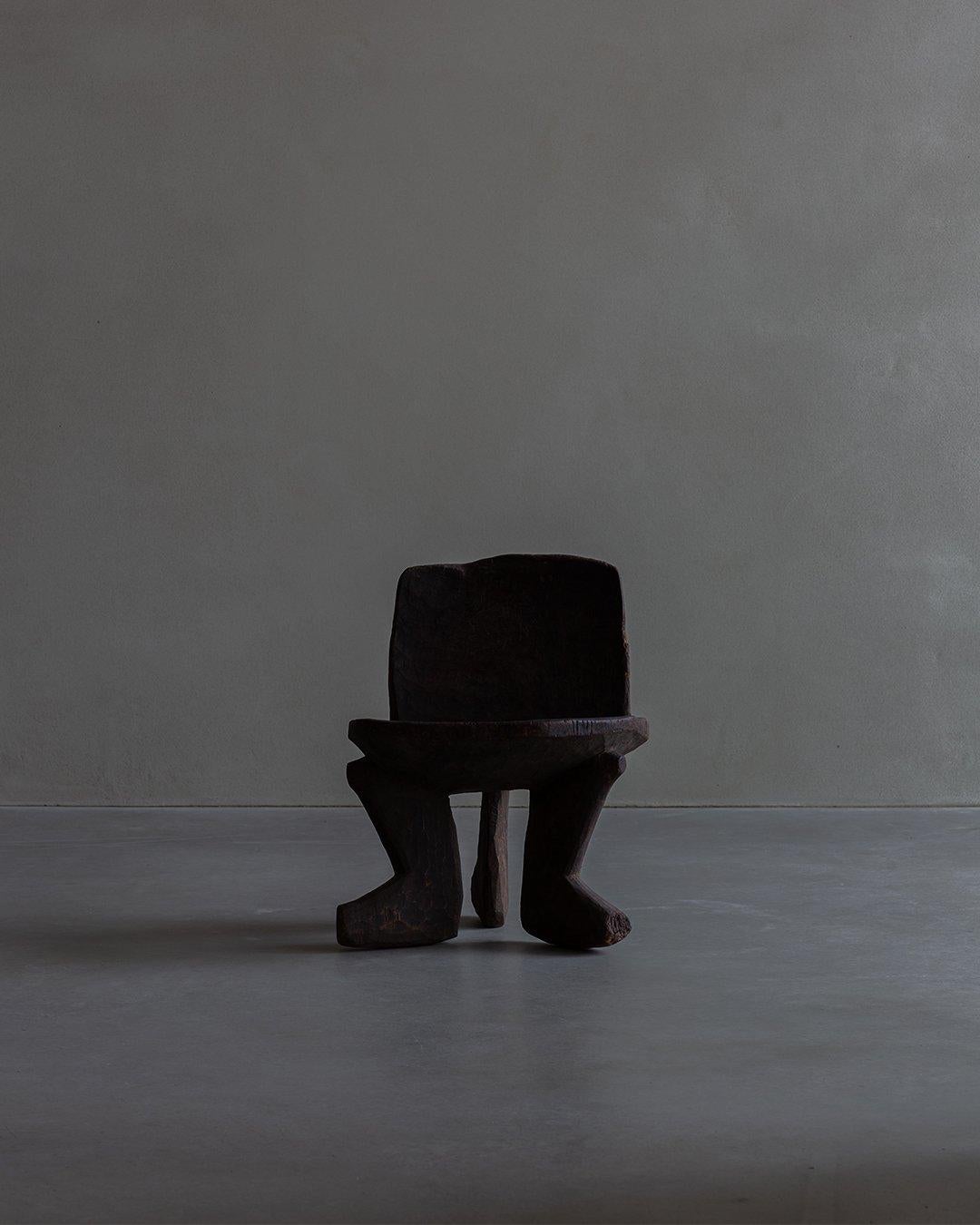 Crafted during the mid-20th century by African artisans using exclusively manual techniques, this stool showcases craftsmanship. The stool's surface has a rich patina, imparting a distinct character and authenticity. Its weathered appearance serves