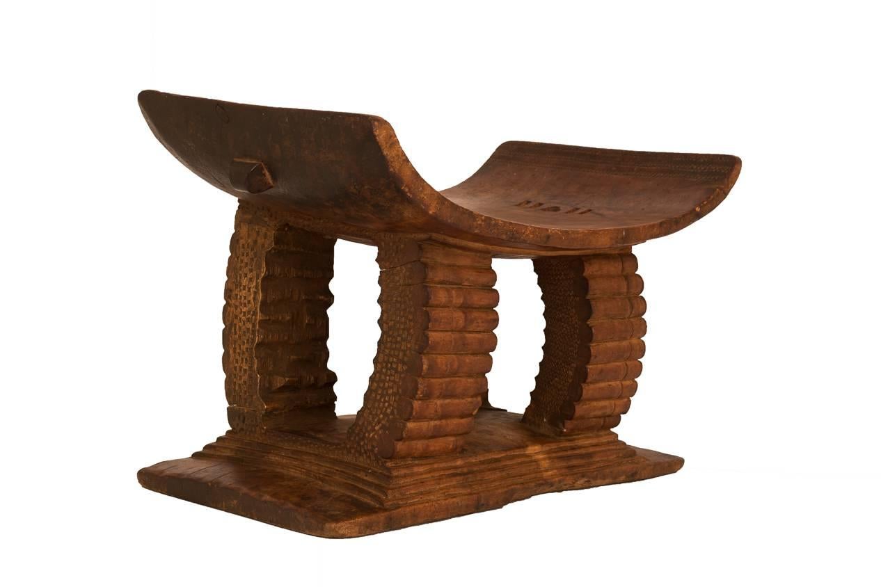 Carved with what seems to be a bullet cartridge motif, this tribal stool makes a wonderful accent piece or decorative object.
