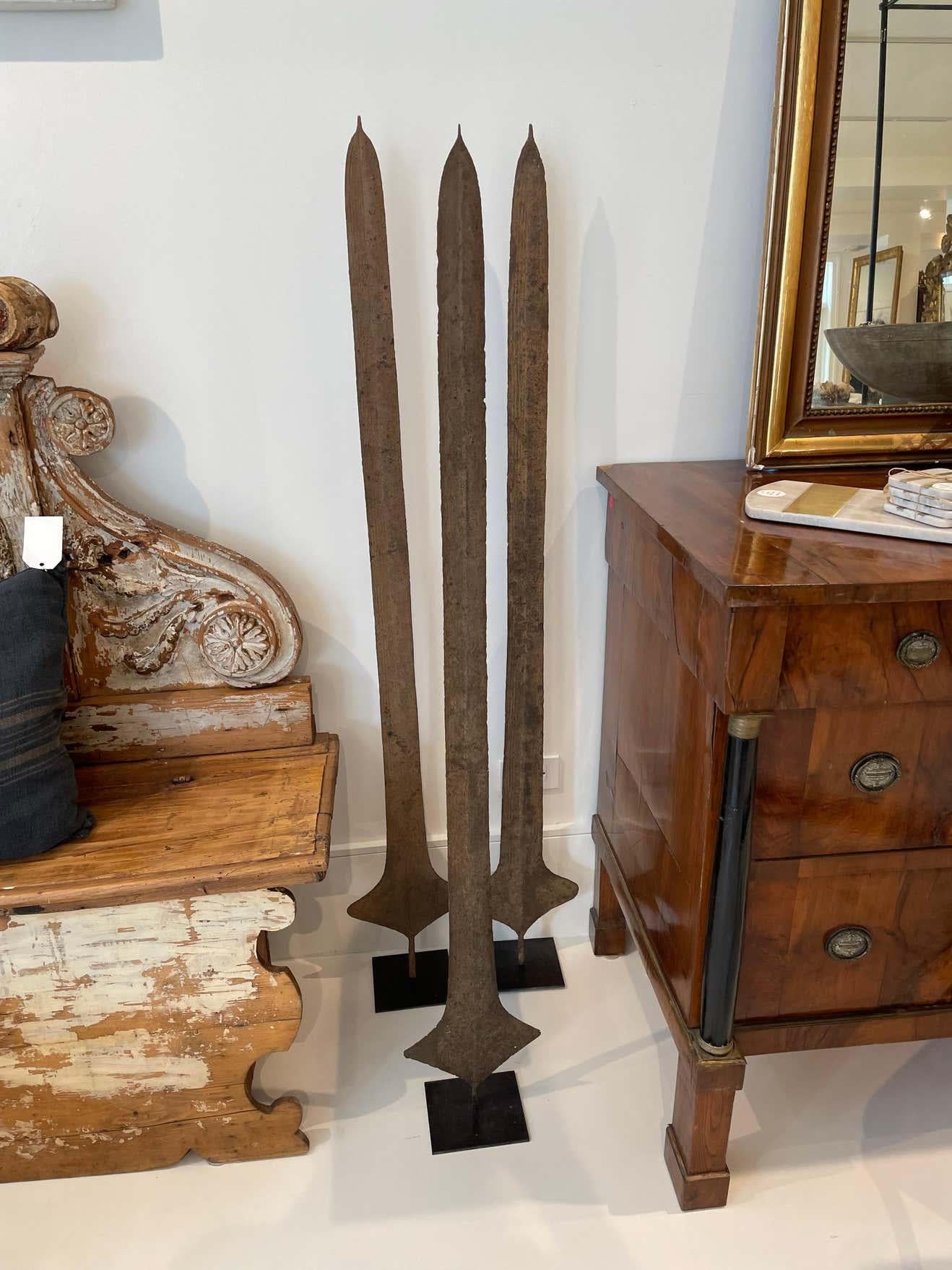 African Currency Sword mounted on a contemporary iron Stand. These were used in the Congo for important transactions such as dowry or land purchases. The patina and sculptural shape give the feel of contemporary art mixed with 19th century history.