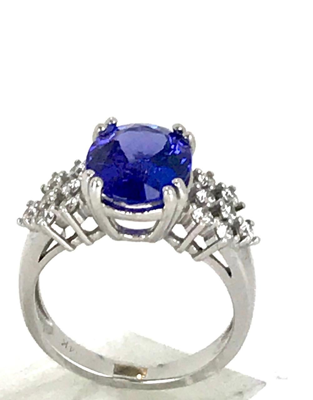 African Tanzanite, 3.20 Ct and .50 Ct VS.Diamond 
Size 7 ring size. 10.20 x 8.50 mm high quality Tanzanite solitaire accented by diamonds on either side 
(14 diamonds total .50 carat total (measuring 1.80 mm each) 
Quality is VS clarity and H color.