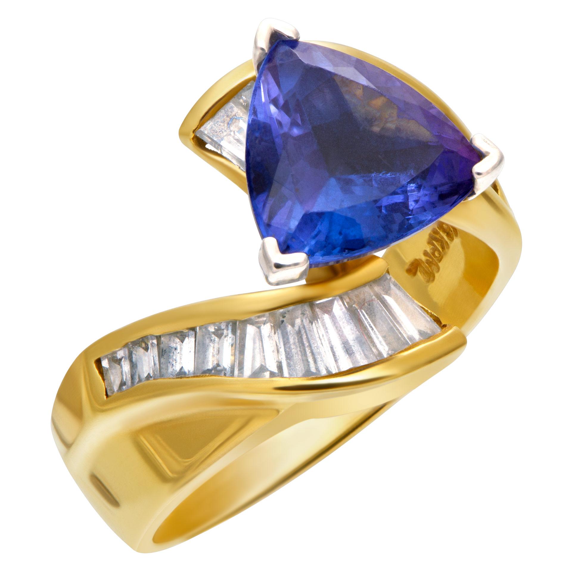 ESTIMATED RETAIL: $3,000 YOUR PRICE: $1,860 - African Tanzanite and diamond ring in 18k yellow gold with approximately 1 carat trillion cut tanzanite and approximately 0.50 carats in baguette diamonds. Width at head: 9.6mm, width at shank: 3.4mm.