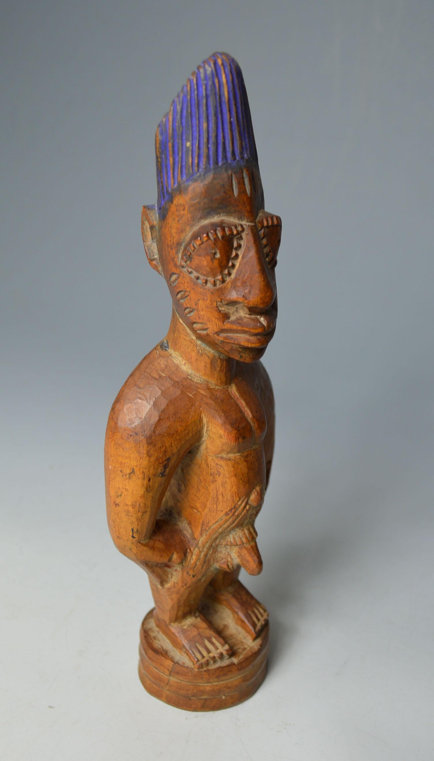 African tribal fine old Yoruba Ibeji Oyo
A finely carved male Ibeji figure from the Igbuke workshop Oyo region Nigeria, standing upright with arms at side with bulging eyes, honey patina crown painted with blue dye the body encrusted with camwood