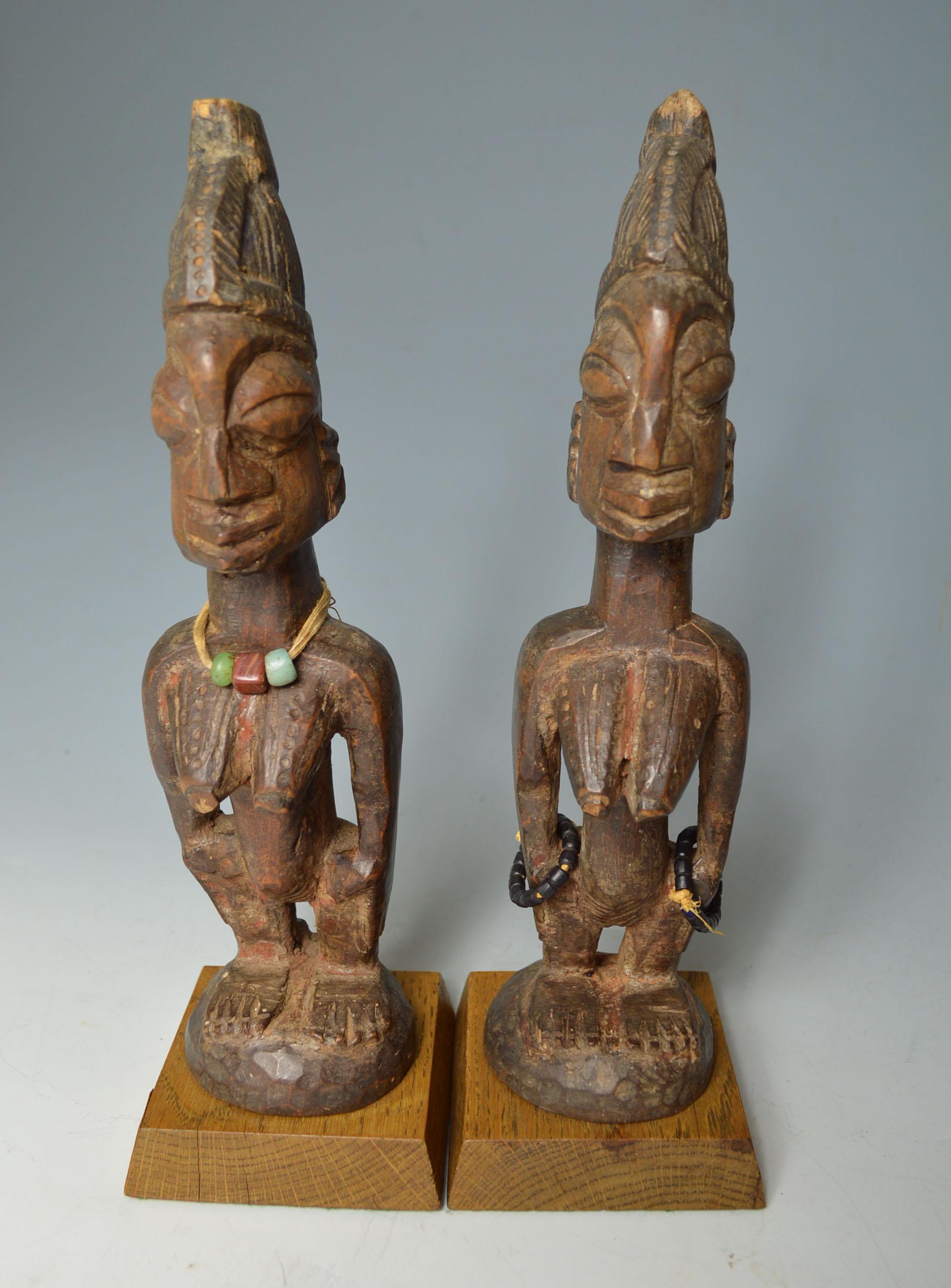 A fine pair of ere Ibeji figures from Ogbomoso Oyo region Nigeria

A pair of hard wood female Ibeji with crest hair style

Showing fine aged patina with camwood powder libation encrustation 

Fine carvings from early 20th century

Measure: