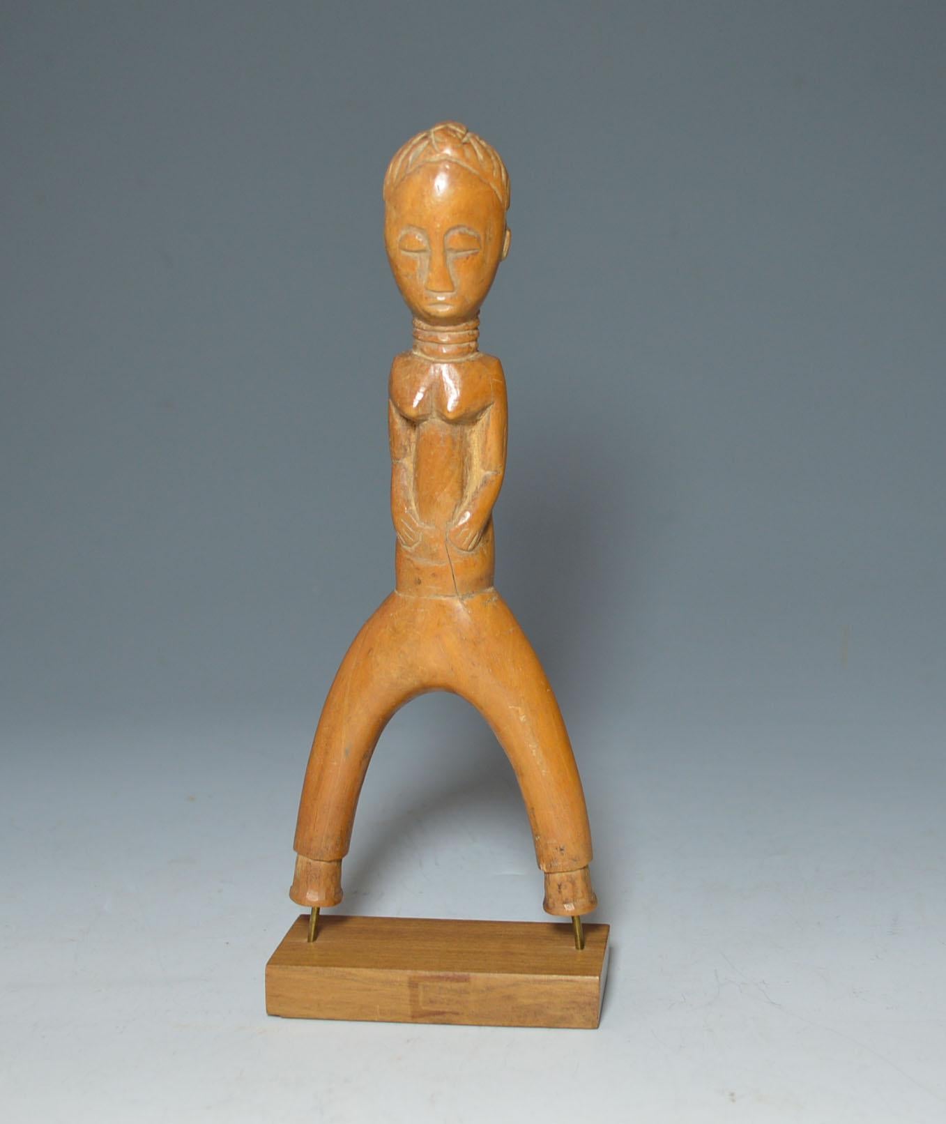 African tribal art Fine Baule figurative catapult or sling shot
Finely carved with a female figure with down cast eyes and hands on Abdomen 
Fine example
Ex Giovanni Sciarli collection
Measures: Height 17.5 cm.
Period early 20th to mid-20th