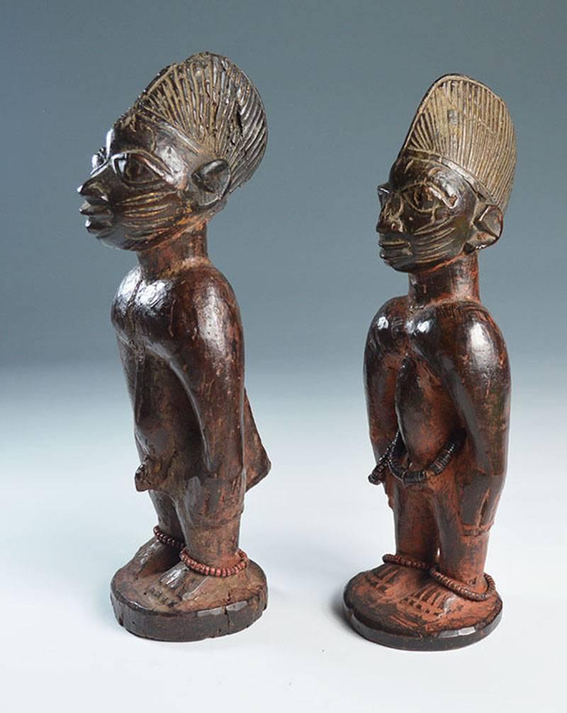 A fine rare pair of ere Ibeji figures from Ibarapa region Nigeria

A pair of hard wood male Ibeji with facial and scarification with crown type headdresses 

Showing fine aged patina and heavily encrusted with cam wood powder

Fine and rare