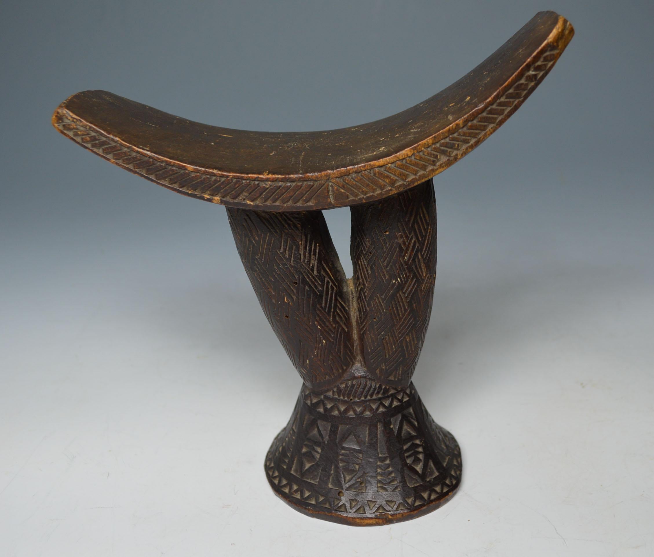 African tribal fine old headrest Afar Danakil Ethiopia
A superb rare example of a Afar or Danakil tribal headrest
Raised on two central branch pillars profusely carved on the underside with geometric patterns
Period:   early 20th century,
Provenance