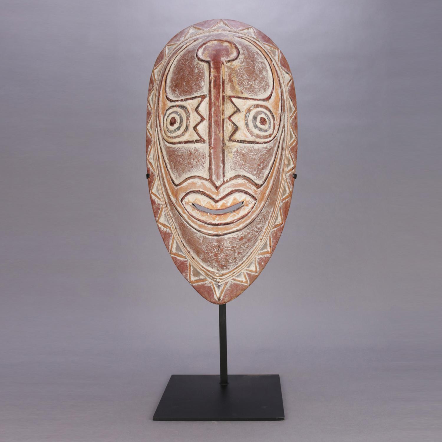 An African tribal hand carved ceremonial mask with stand, 20th century.

Measures: 35