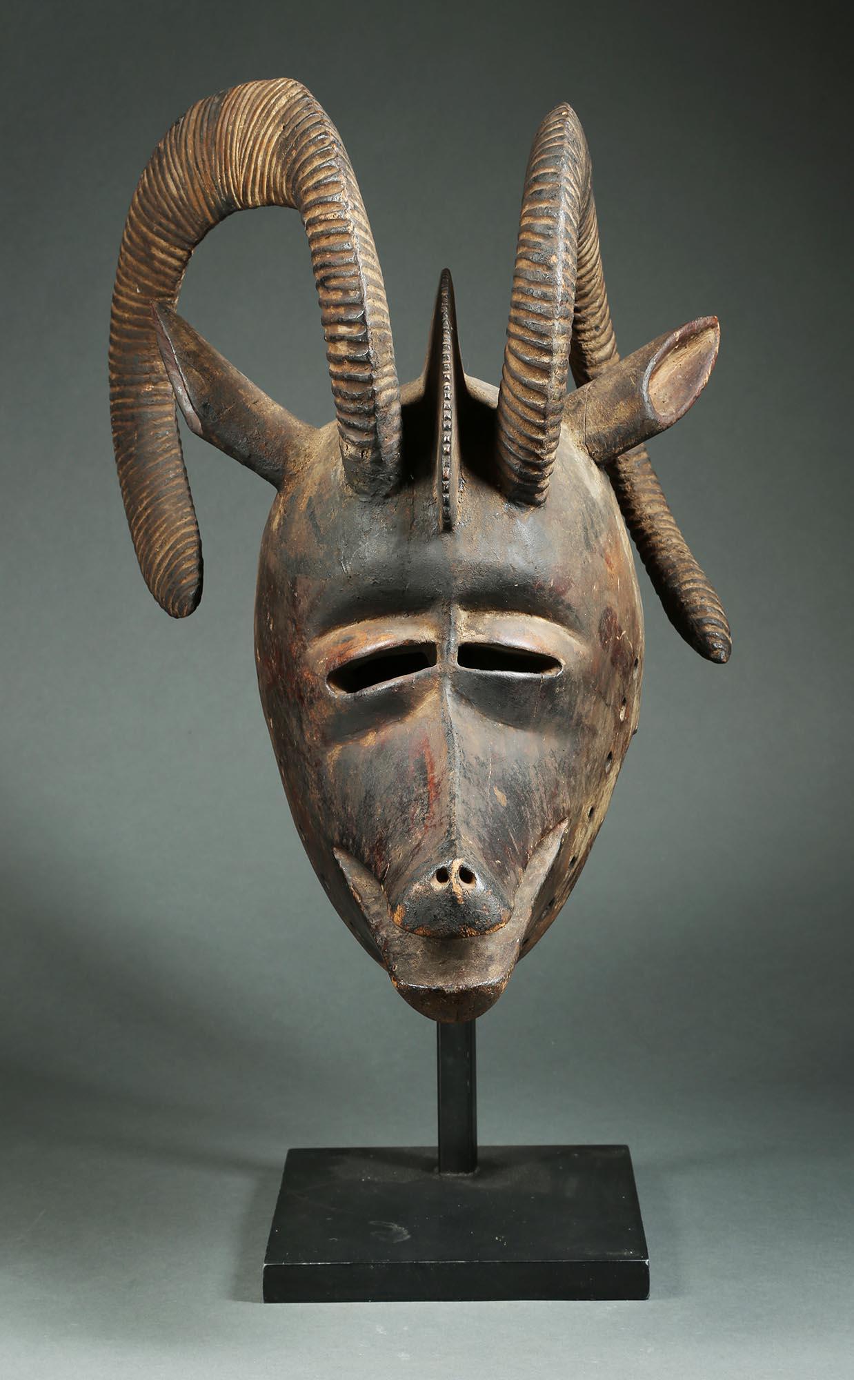 A large hardwood helmet mask representing a ram from the Bobo people of Burkina Faso, West Africa. Lively asymmetrical horns encircle the top of the head. Created in the early to mid-20th century.
A very similar mask, probably by the same carver,
