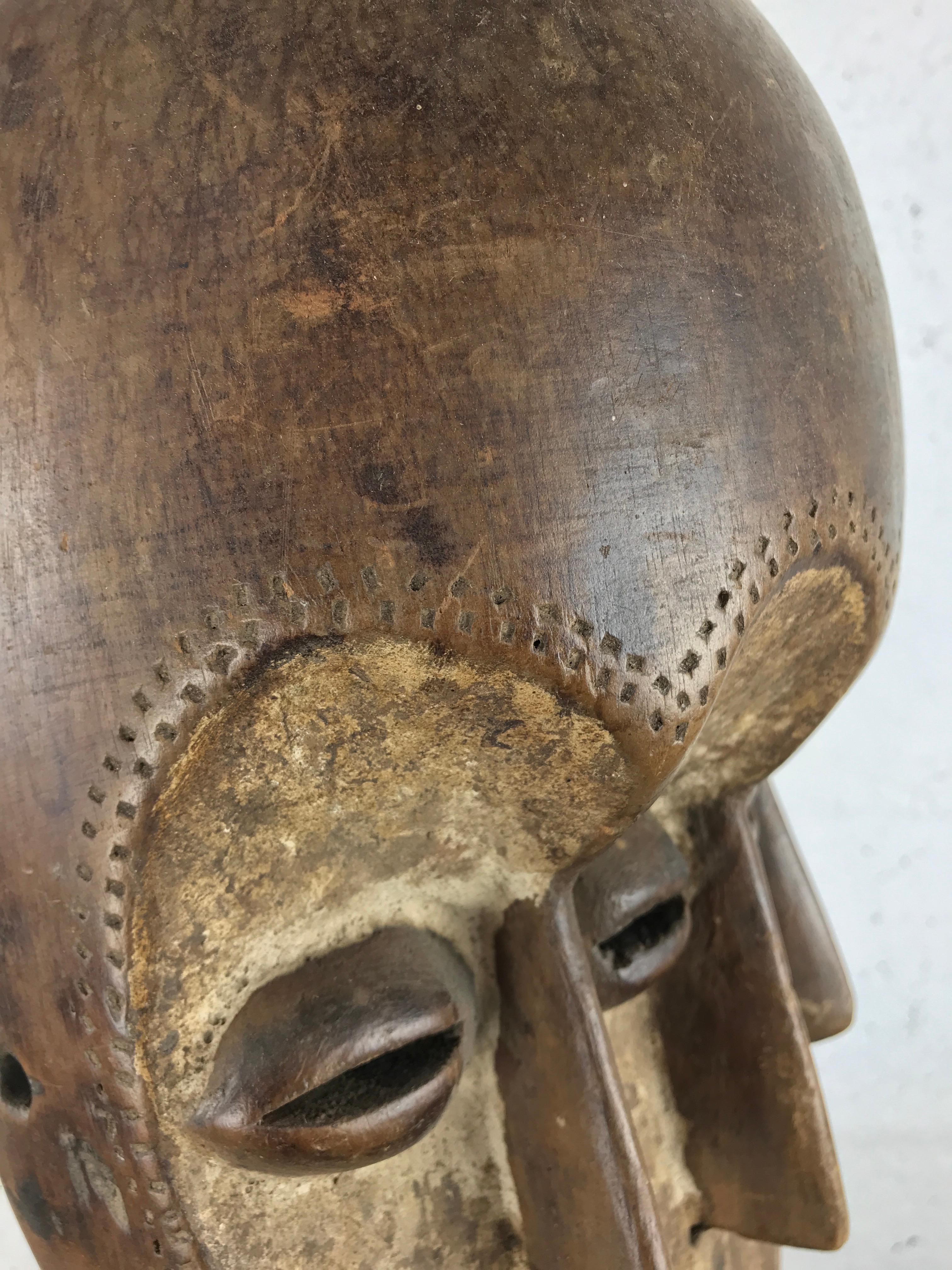 Hand-Carved African Tribal Mask with Three Faces – Lega People, Congo, 20th Century For Sale