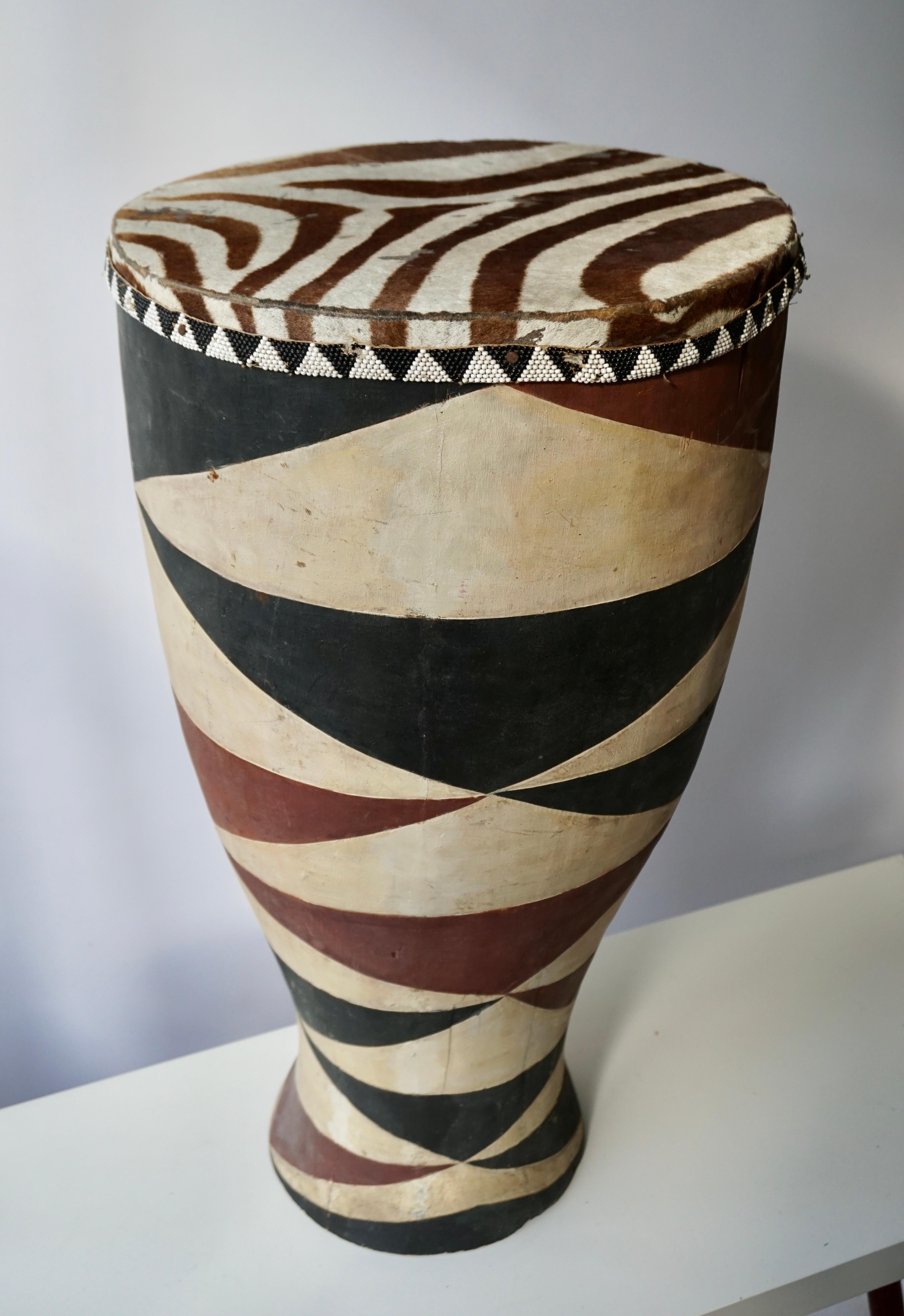 African hide drum table, hand carved and painted base with leather zebra roping. A handsome side or coffee table for rooms from modern to Ethnic. The perfect way to add, not only character but dimension and texture. Congo, Rwanda,