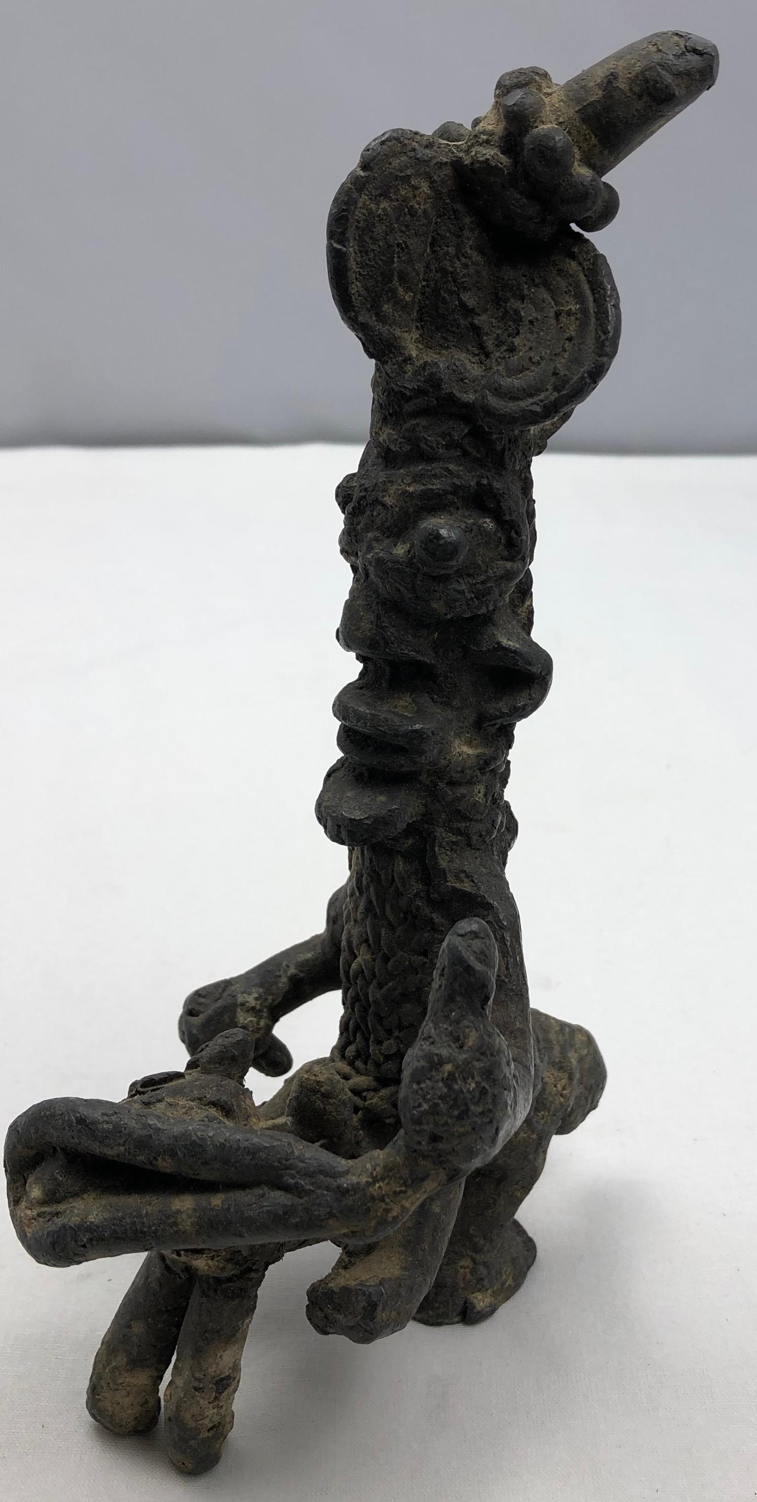 Interesting African tribal sculpted statue made of iron or lead. 
It almost appears that the materials used were taken from a sunken ship. 
Look closely at the images for details. 
Measures 8 3/4