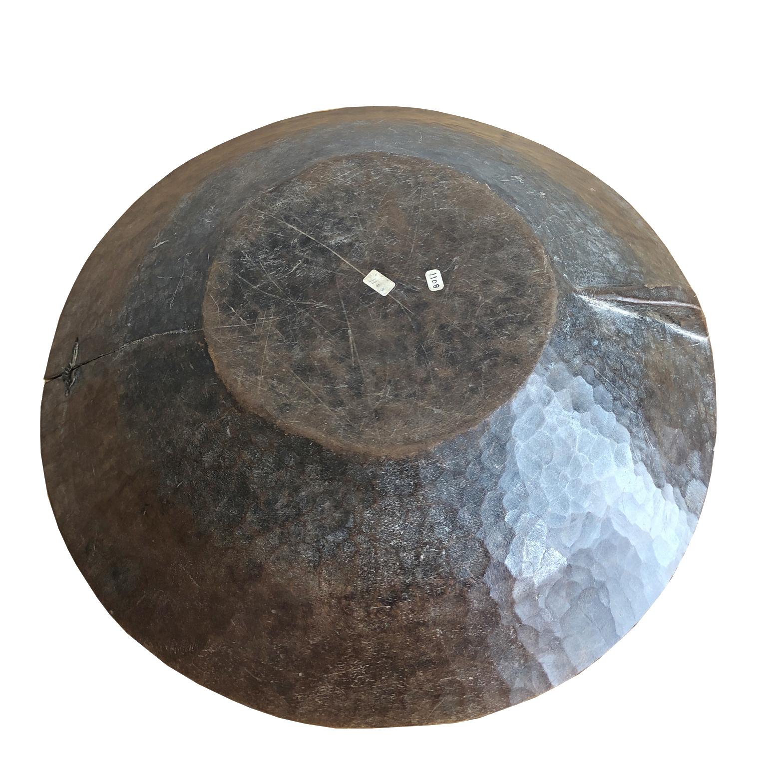A beautiful wooden bowl in a milk-chocolate, brown color with incised carvings along the border made by the Gala or Karo people in Southern Ethiopia and carved out of a solid block of wood, it served as a utilitarian object in everyday tribal life