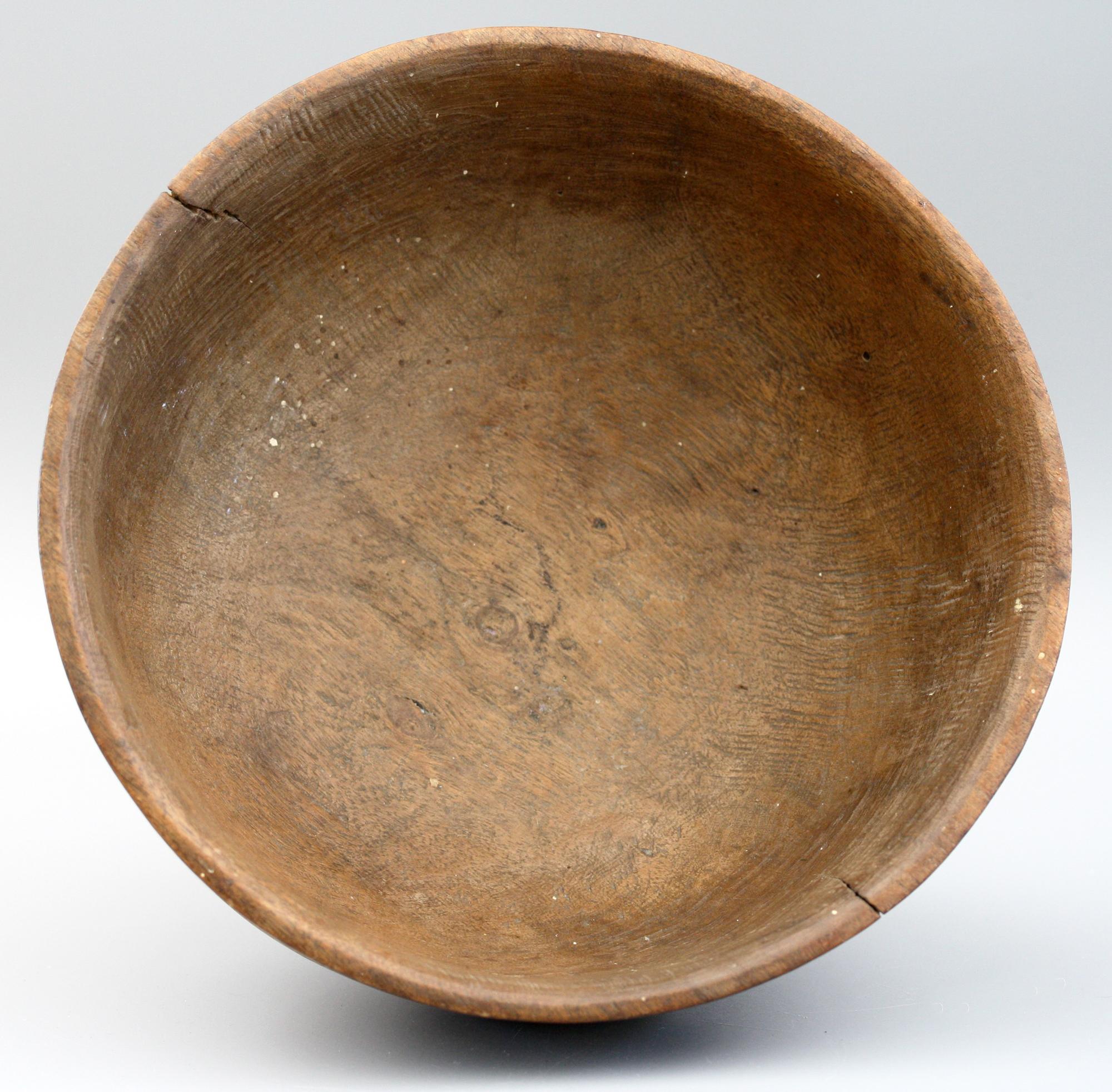 An interesting and well carved antique African, probably Nigerian, tribal wooden pedestal bowl or mortar dating from the early 20th century. The bowl is carved from a single piece of wood and stands on a rounded pedestal foot with cut out elements