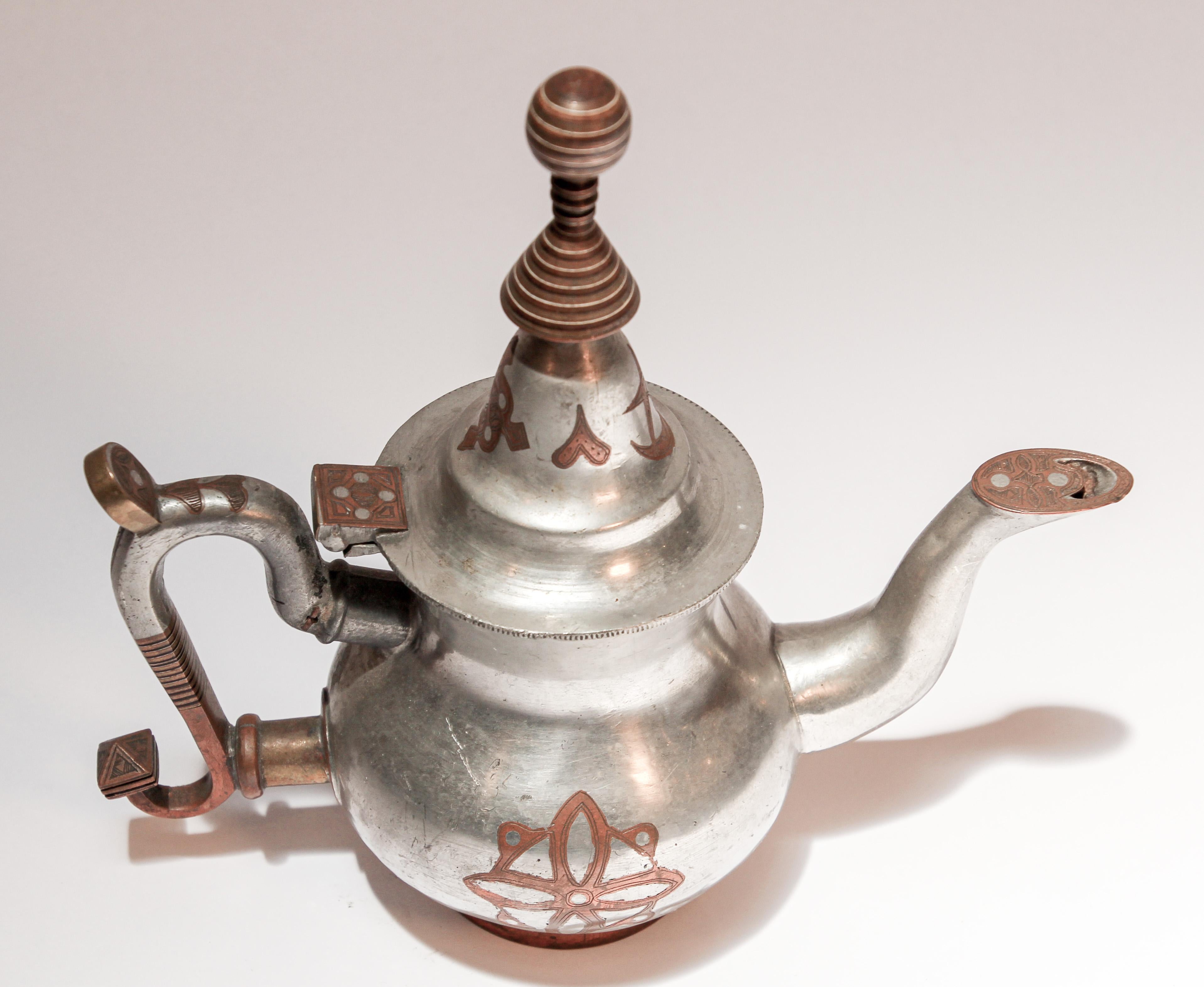 Mid-20th century Tuareg teapot from Mauritania, Africa, Western Sahara.
Handcrafted of pewter, copper and brass decorations.
The Tuareg people inhabit a large area, covering almost all the middle and western Sahara and the north-central