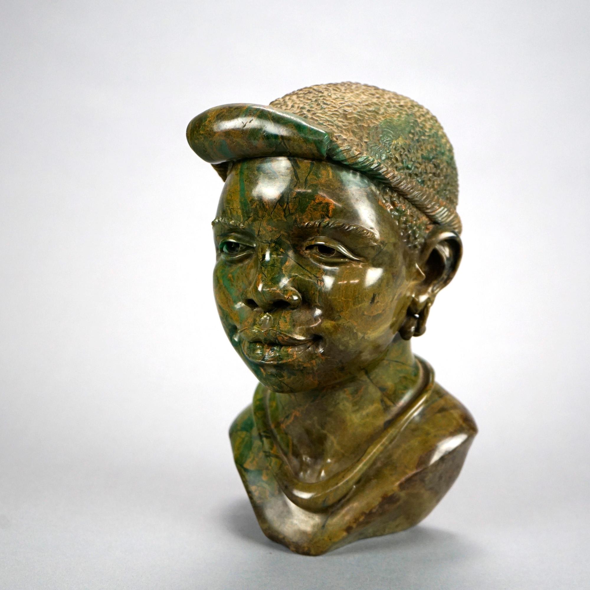 An African carved stone sculpture offers hand carved Vérdité portrait bust of a tribal woman, 20th c

Measures- 10'' H x 5.5'' W x 6.25'' D.