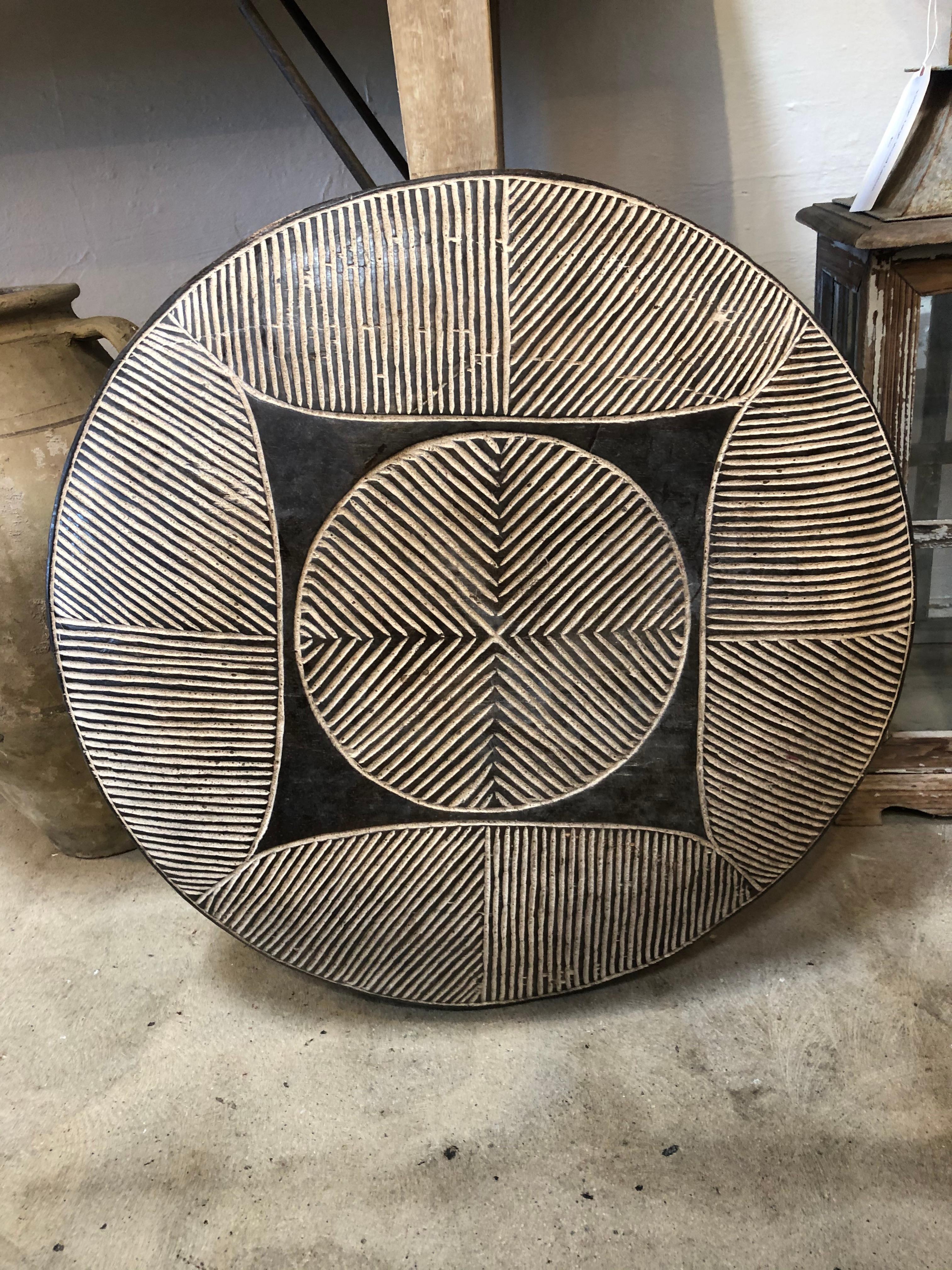 Hand carved African Warrior Shield from the early 20th century. These light-weight shields were used during combat, as opposed to heavier ones, to increase mobility. The geometric patterns featured on each individual shield also had rank and status
