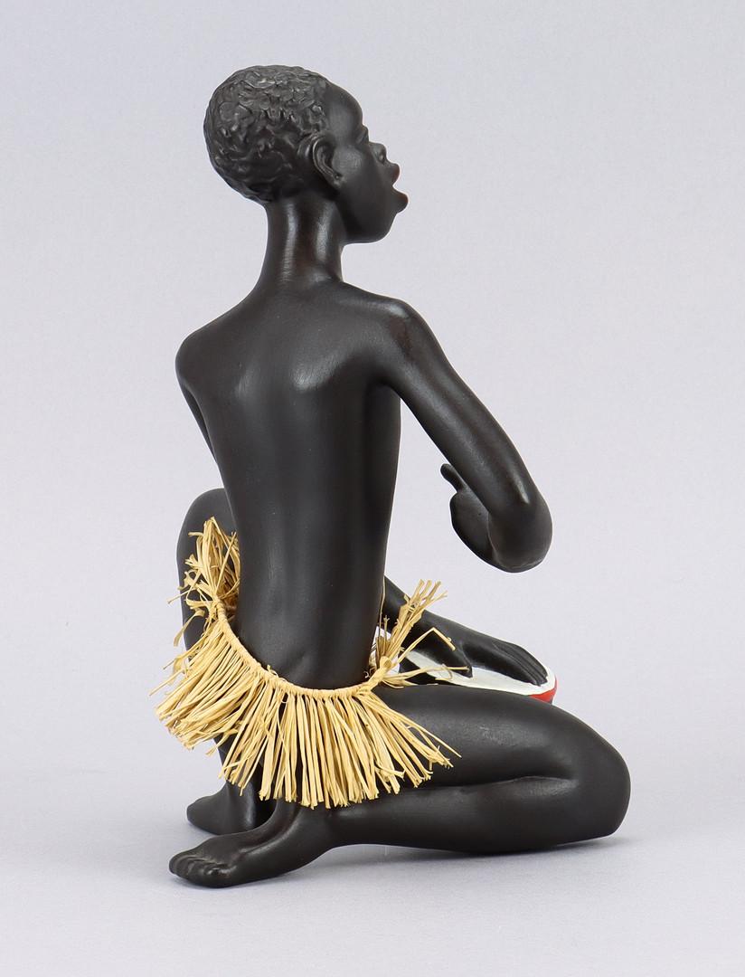 A detailed ceramic figurine showing an African with drum. Manufactured by Gmundner Kerami in the 1950s. 