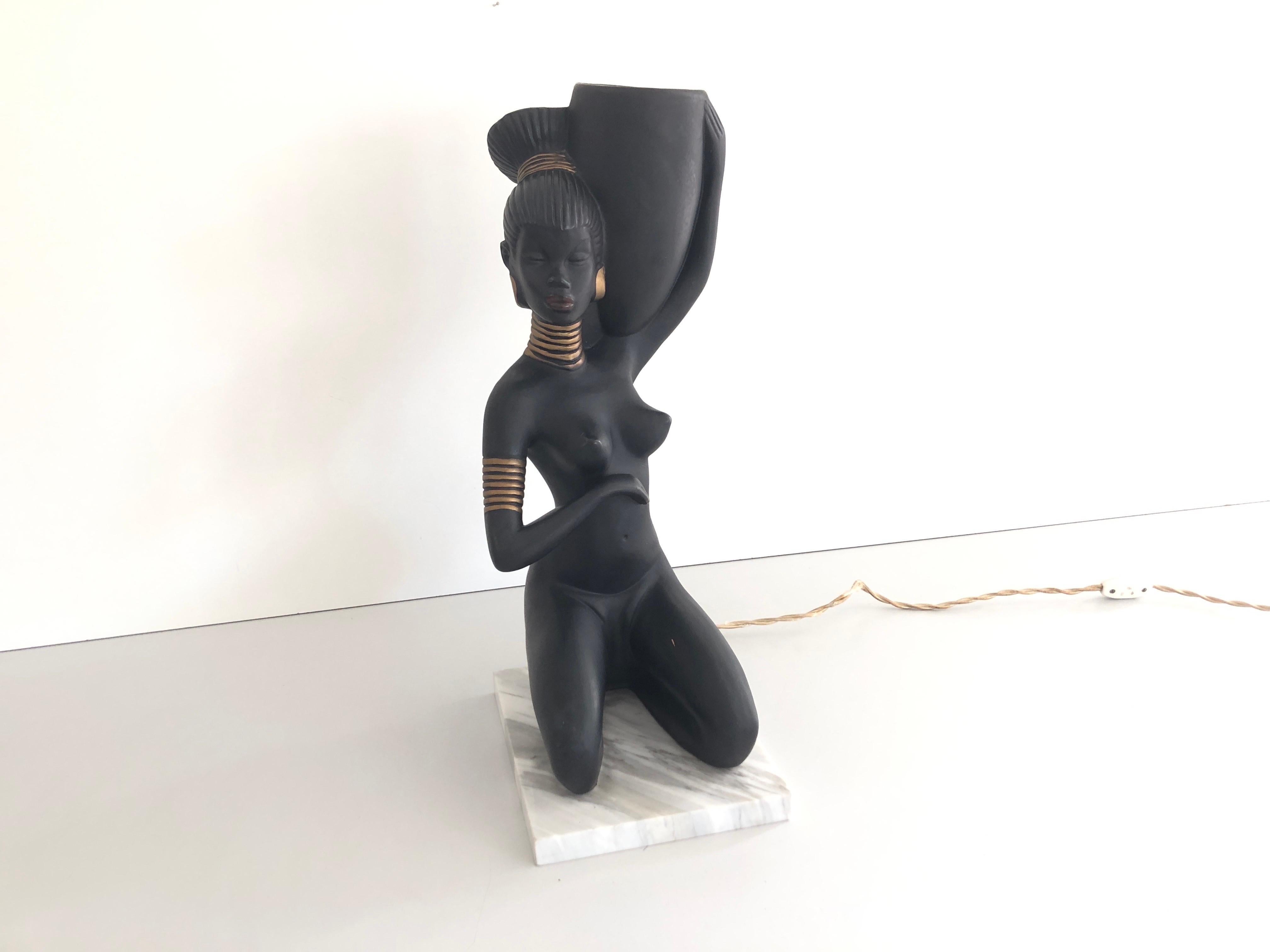 African Woman Ceramic Large Table Lamp, 1960s, Italy

Lamp is in very good vintage condition.

The base is made of marble.

Weight: 5,3 kg

It has European plug. It can be converted to other countries plugs with using converter. Also it can be