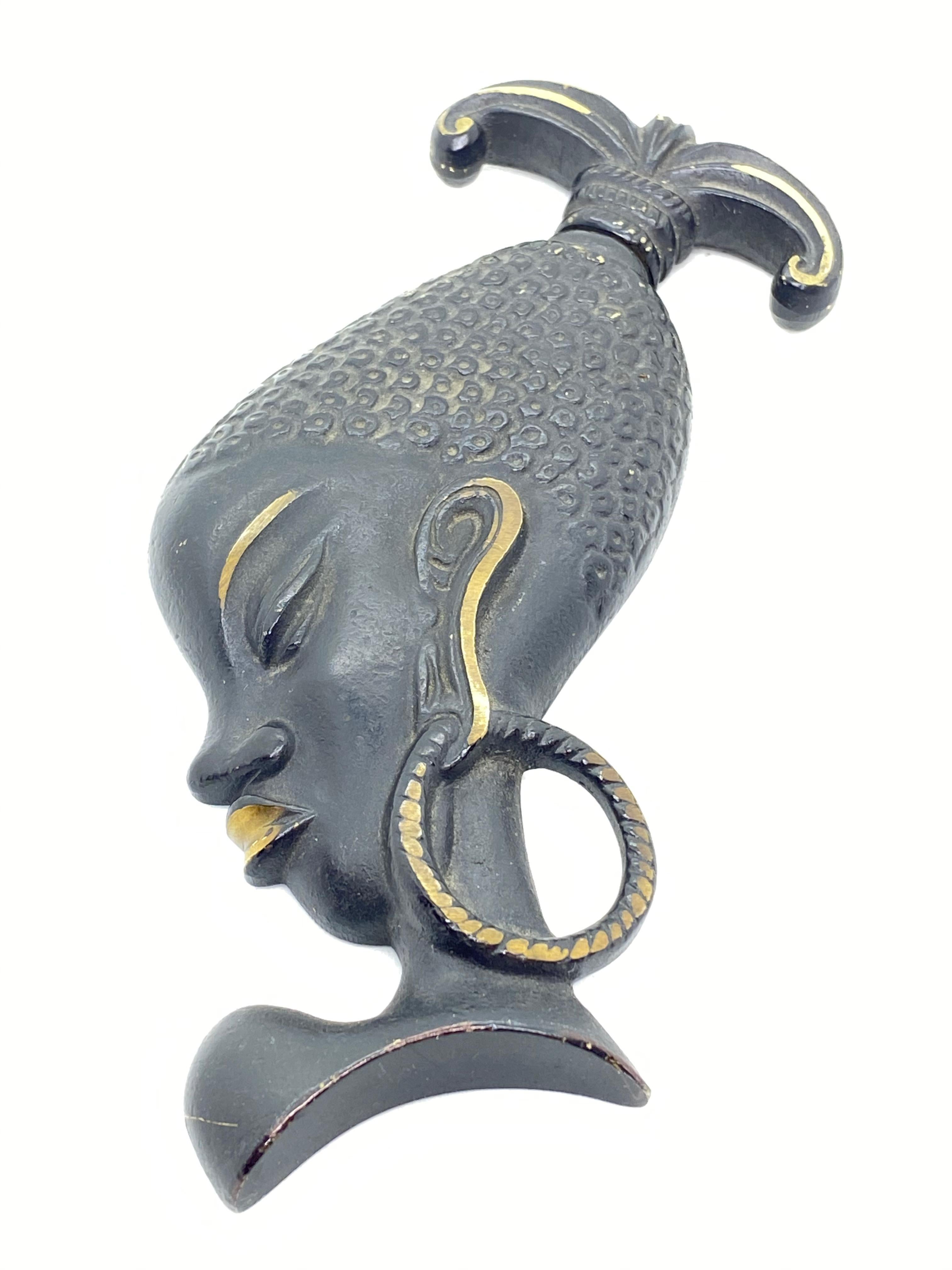 Classic early 1950s Austrian corkscrew in the form of an African Woman Head. Has a hook to be attached at the wall. Nice addition to your room or just for your collection of Austrian bronze items. Found at an estate sale in Vienna, Austria.