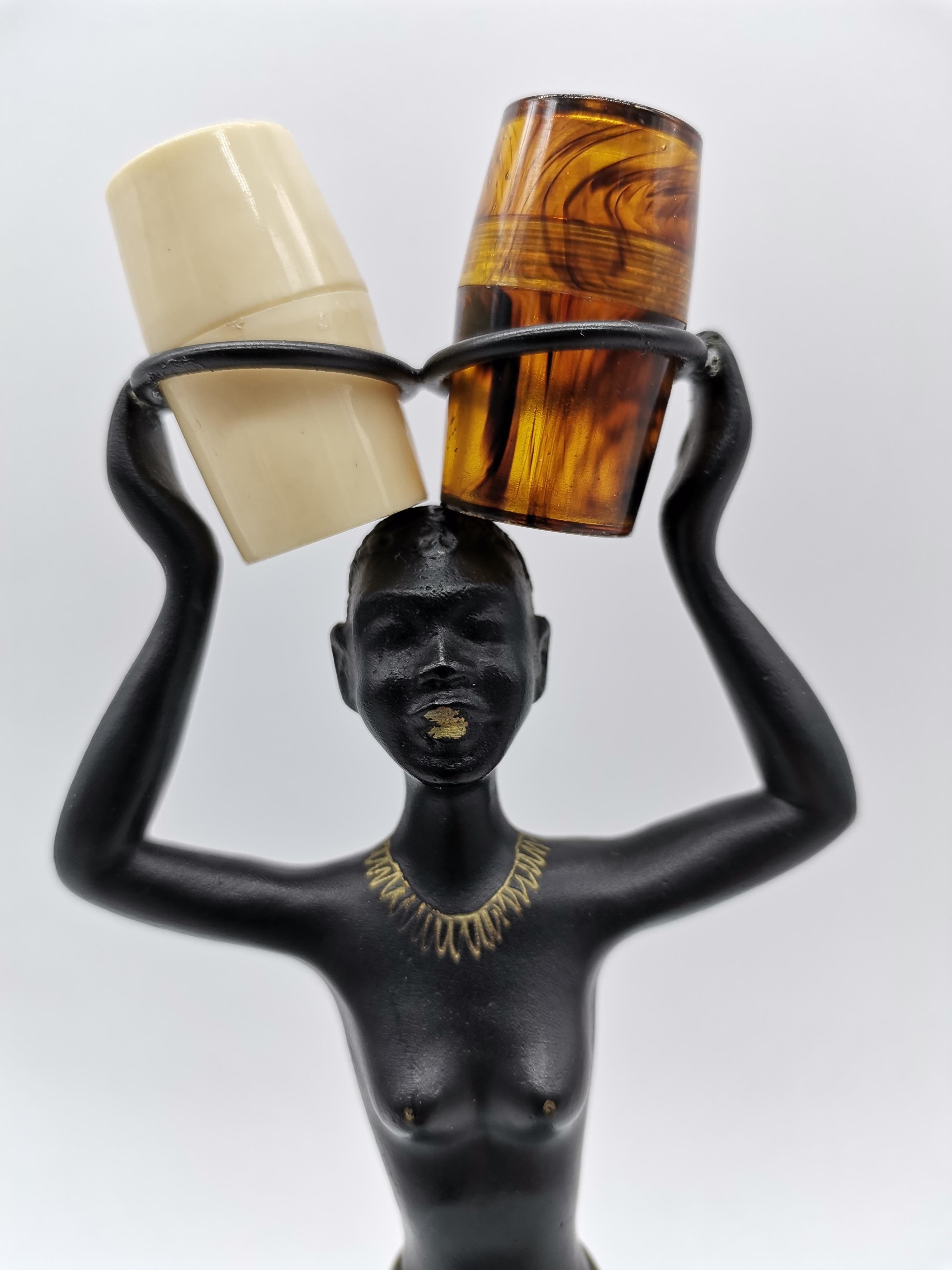 Salt and Pepper Shaker holder in form of an african woman. In style of Richard Rohac. Shakers are made of plastic.