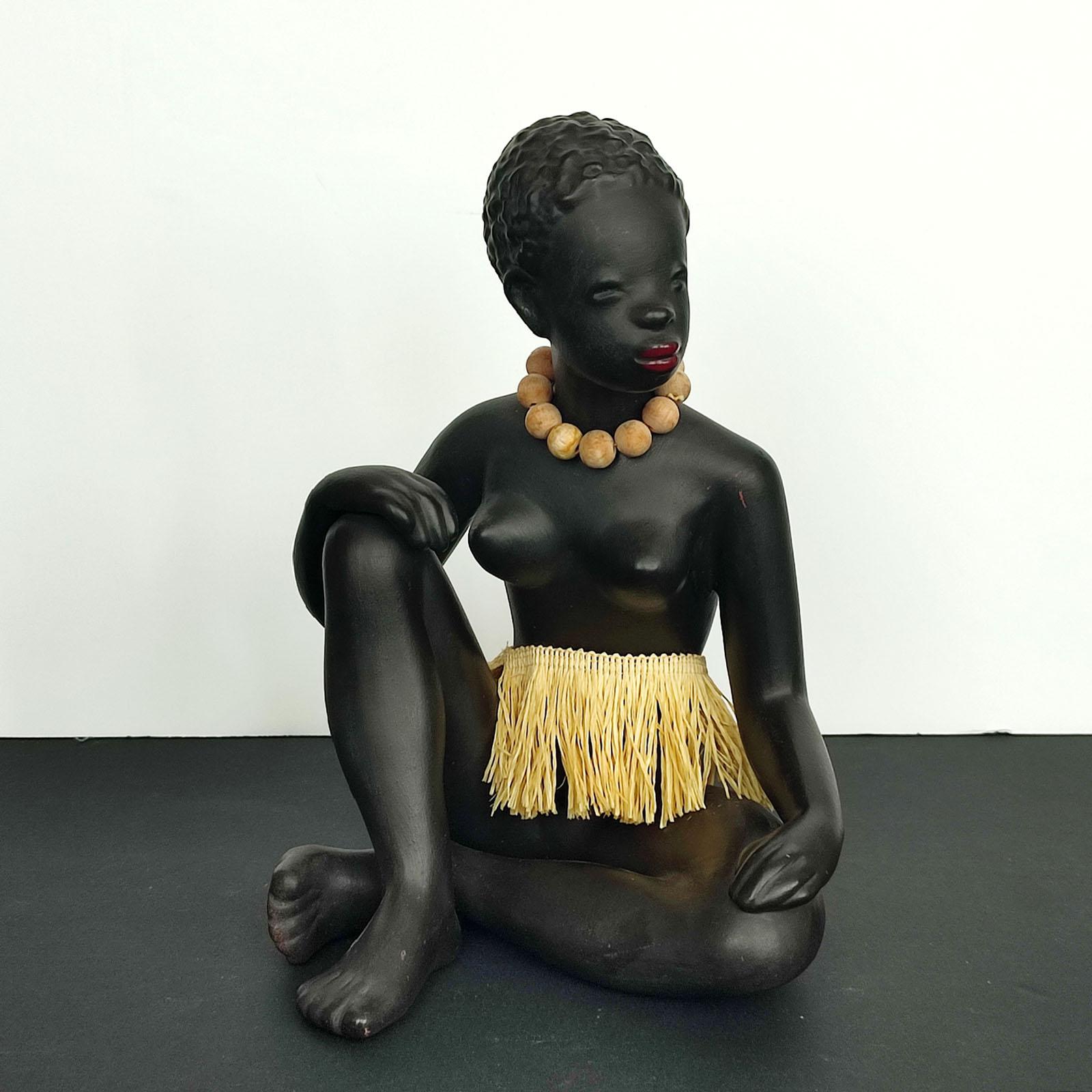 Exotic African women sculpture by Leopold Anzengruber, Vienna 1950s.
Terracotta, mate black finish. Original necklace and skirt. Numbered under the bottom.
Good over all condition, minor scratches, no chips, no cracks. 
Measures: Height 24 cm