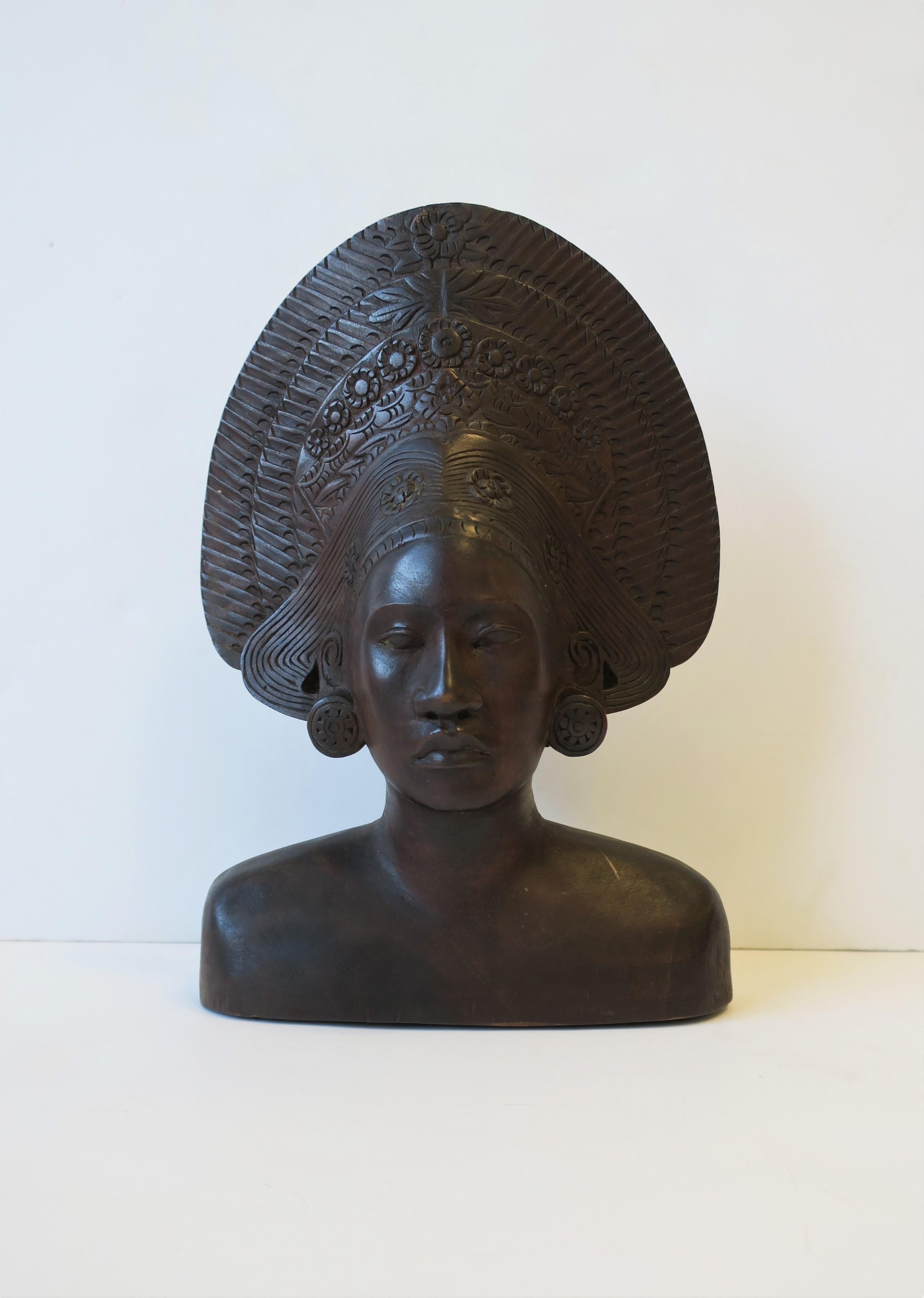 A very beautiful, detailed, African wood female bust figurative sculpture piece made for Western export, circa 20th century, Africa. Sculpture is a rich deep brown hue, hand carved and polished from one piece of wood. 

Piece measures: 3.25