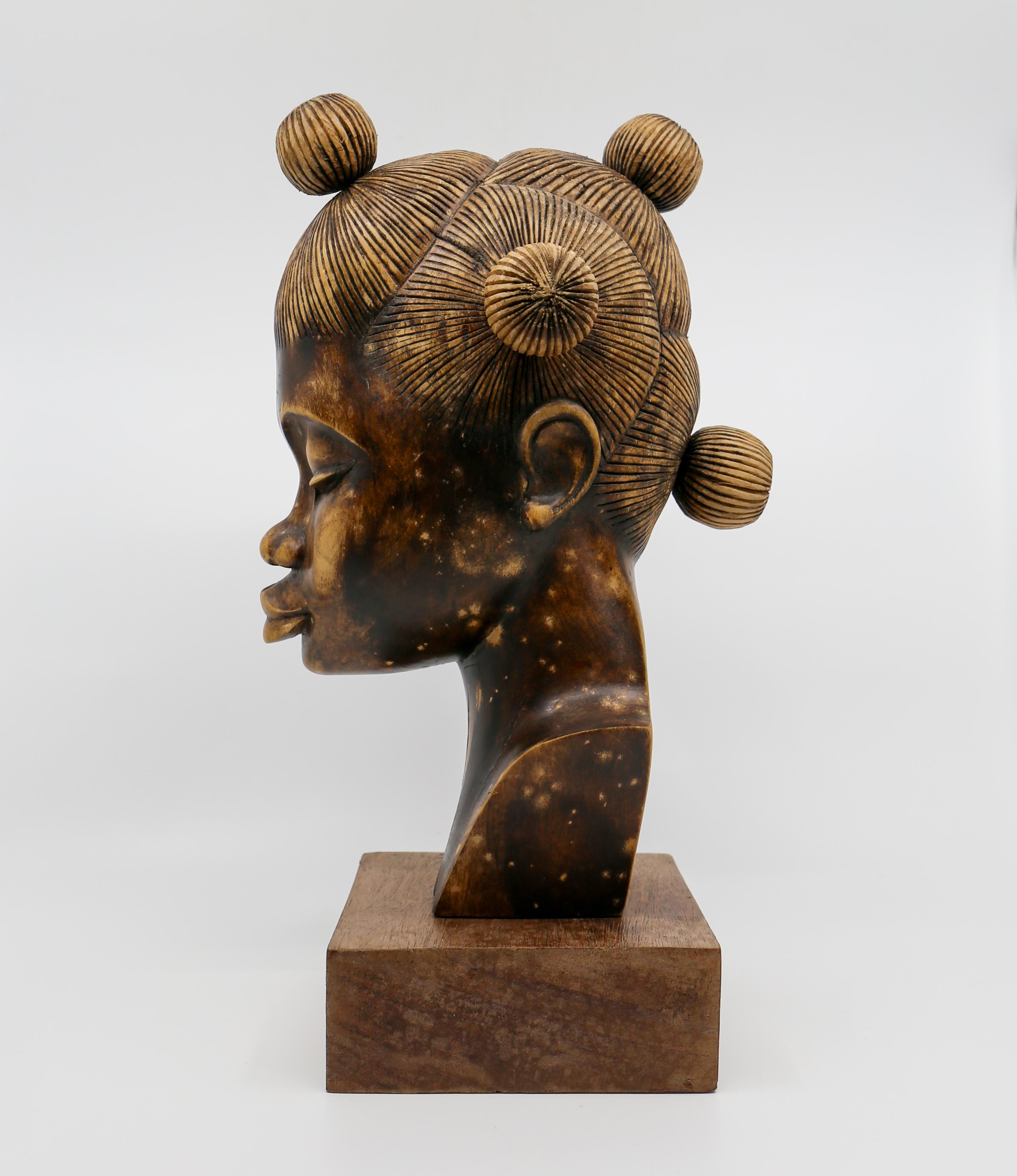 A very beautiful, detailed, African wood female bust figurative sculpture piece made for Western export, early 20th century, Africa. Sculpture is a rich deep brown hue, hand carved and polished from one piece of wood.  