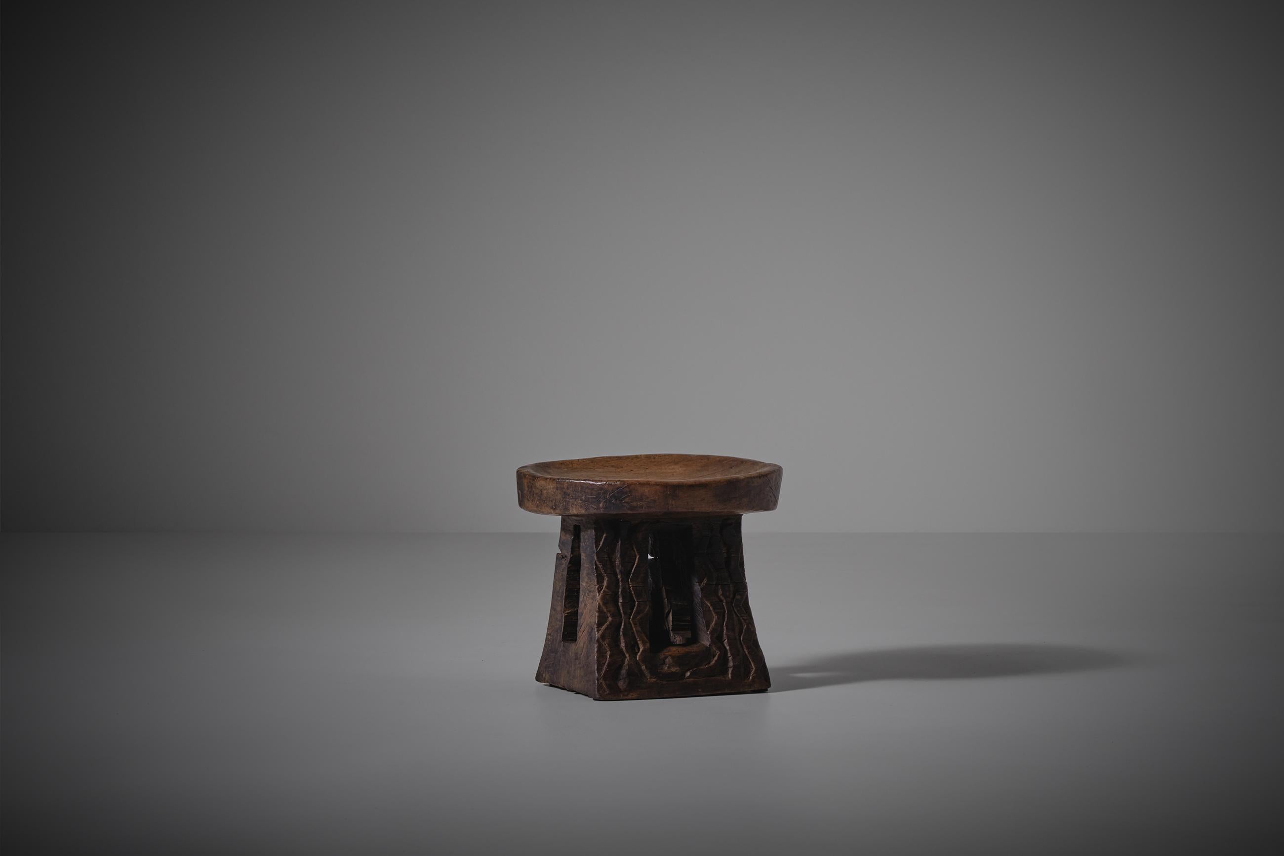 African Wooden 'Bamileke' stool, early XX century. The stool is a traditional art populair from Cameroon. These hand-carved stools have long been used as ceremonial seating to indicate the status and power of tribal chiefs and kings. Each stool is
