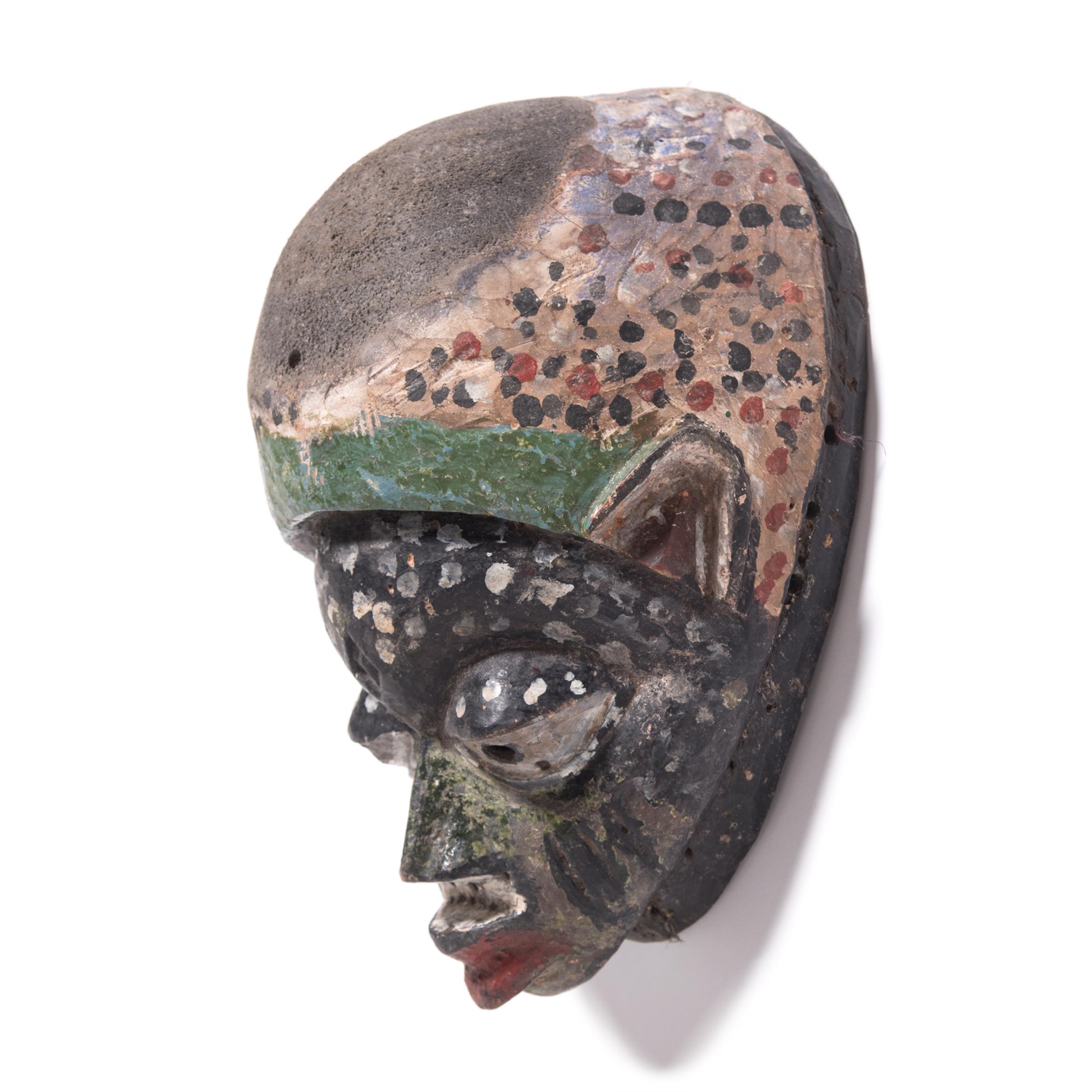 This painted mask was created by the Yoruba People of western Nigeria, and was worn during a tradition known as Gelede. A blend of ritual and artistic spectacle, Gelede pays homage to the women of their Community, understood to possess spiritual