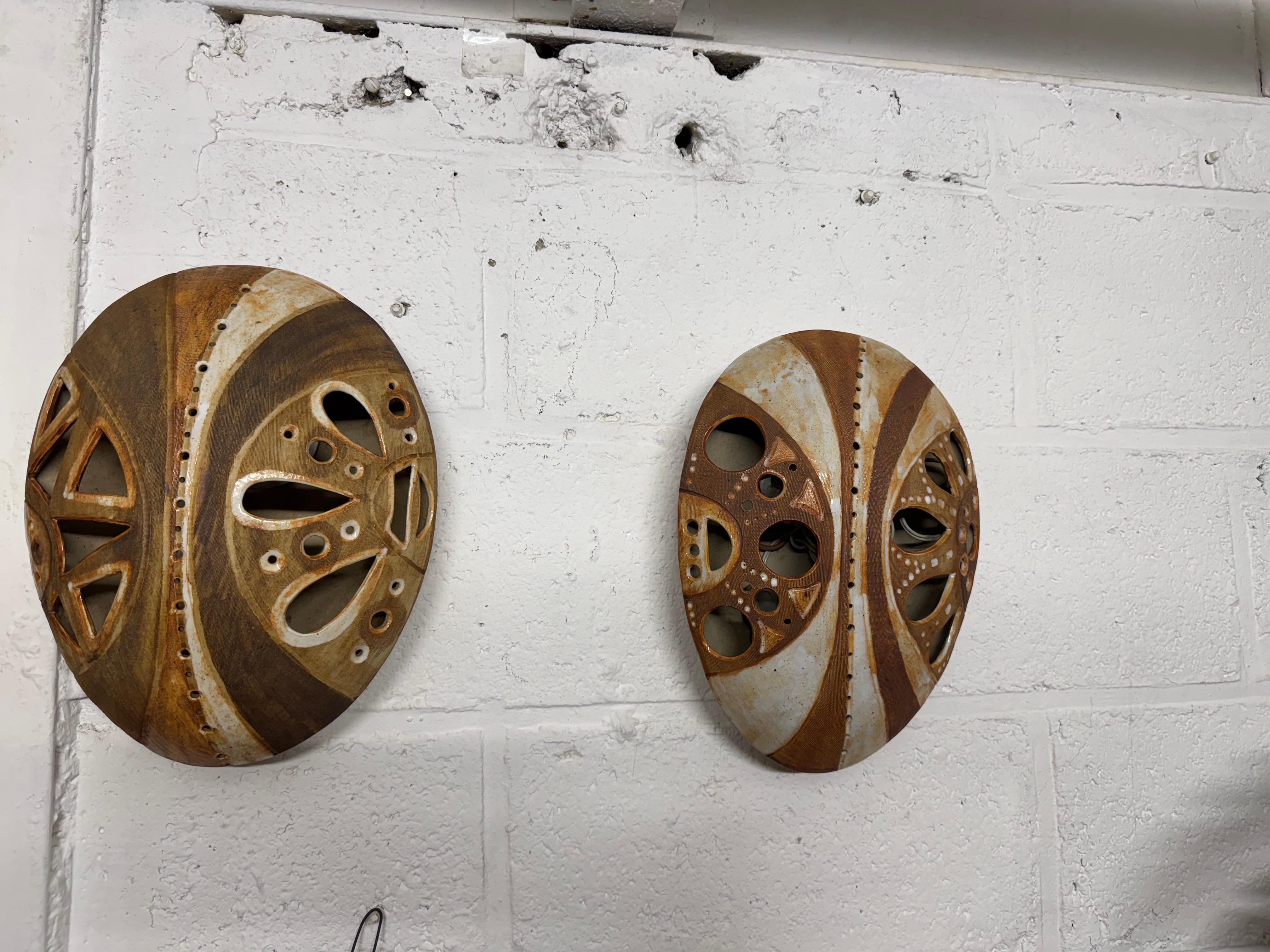 French Africanist ceramic pair of sconces For Sale