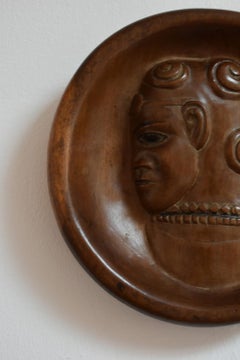Africanist low relief round wooden wall sculpture, 1970s.