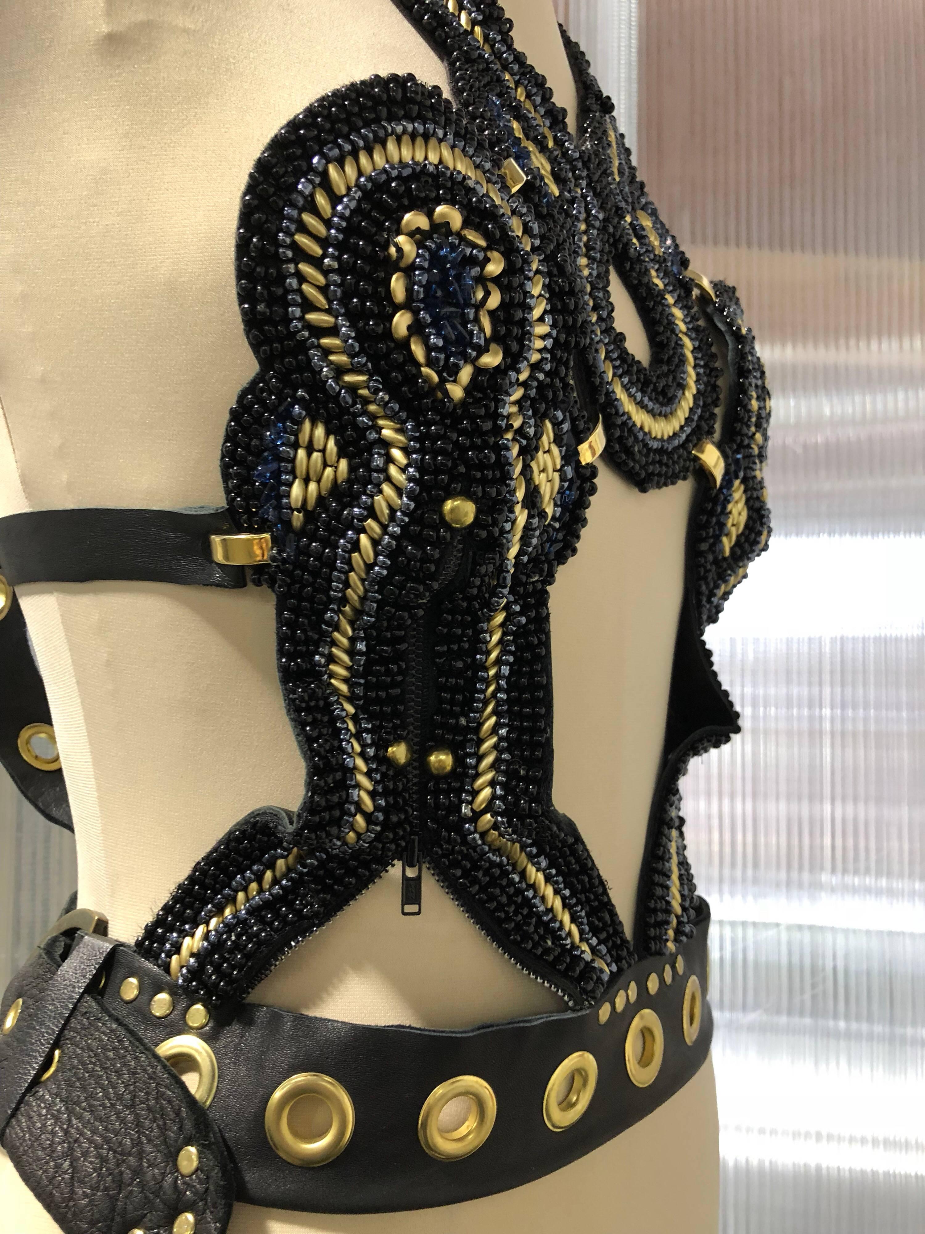 Artisan-made AfroPunk wood beaded harness with leather straps, gold studs and buckles. Completely lined in black kid leather.  Adjustable fit with buckles at back and sides.  Fits size 6-8
