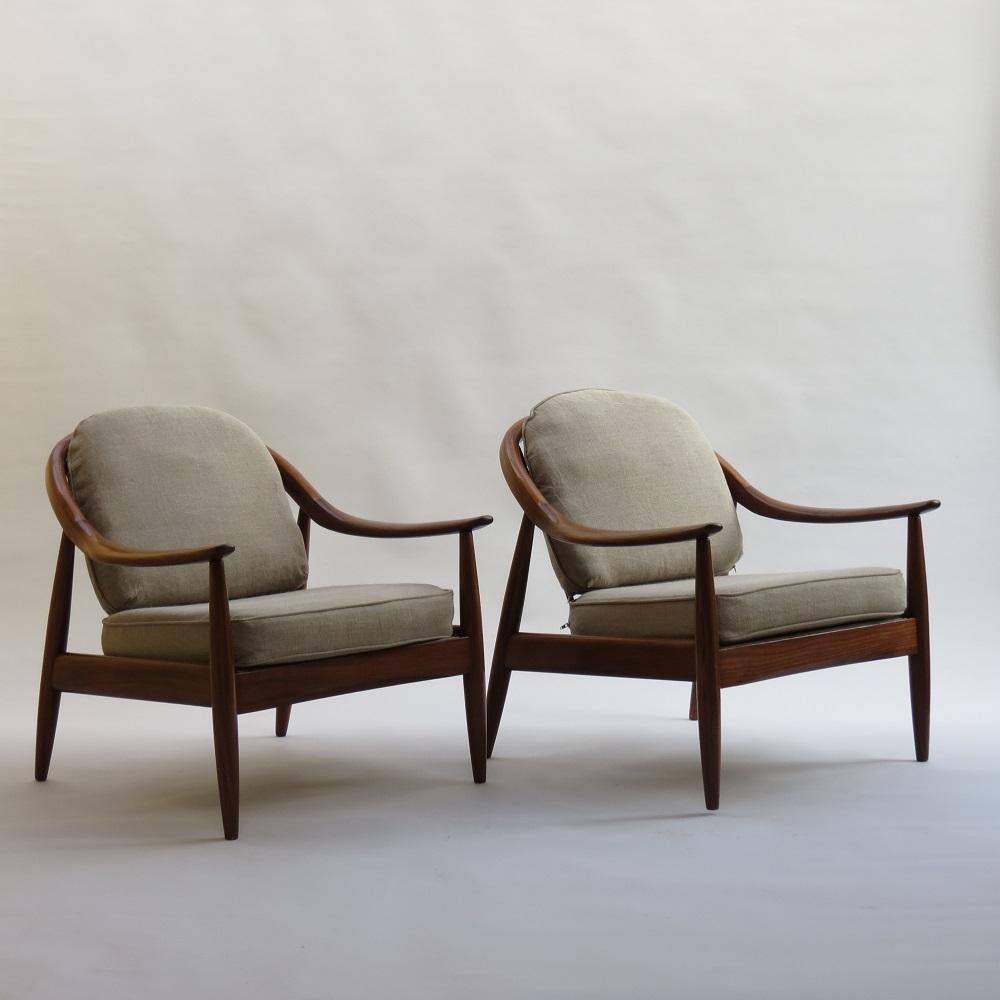 Wonderful pair of armchairs from the 1960s.  Designed and manufactured by Greaves and Thomas, UK.

Made from solid Afrormosia, curved back rails and spindle backs.

New webbing to the seats, the cushions a have been reupholstered at some point