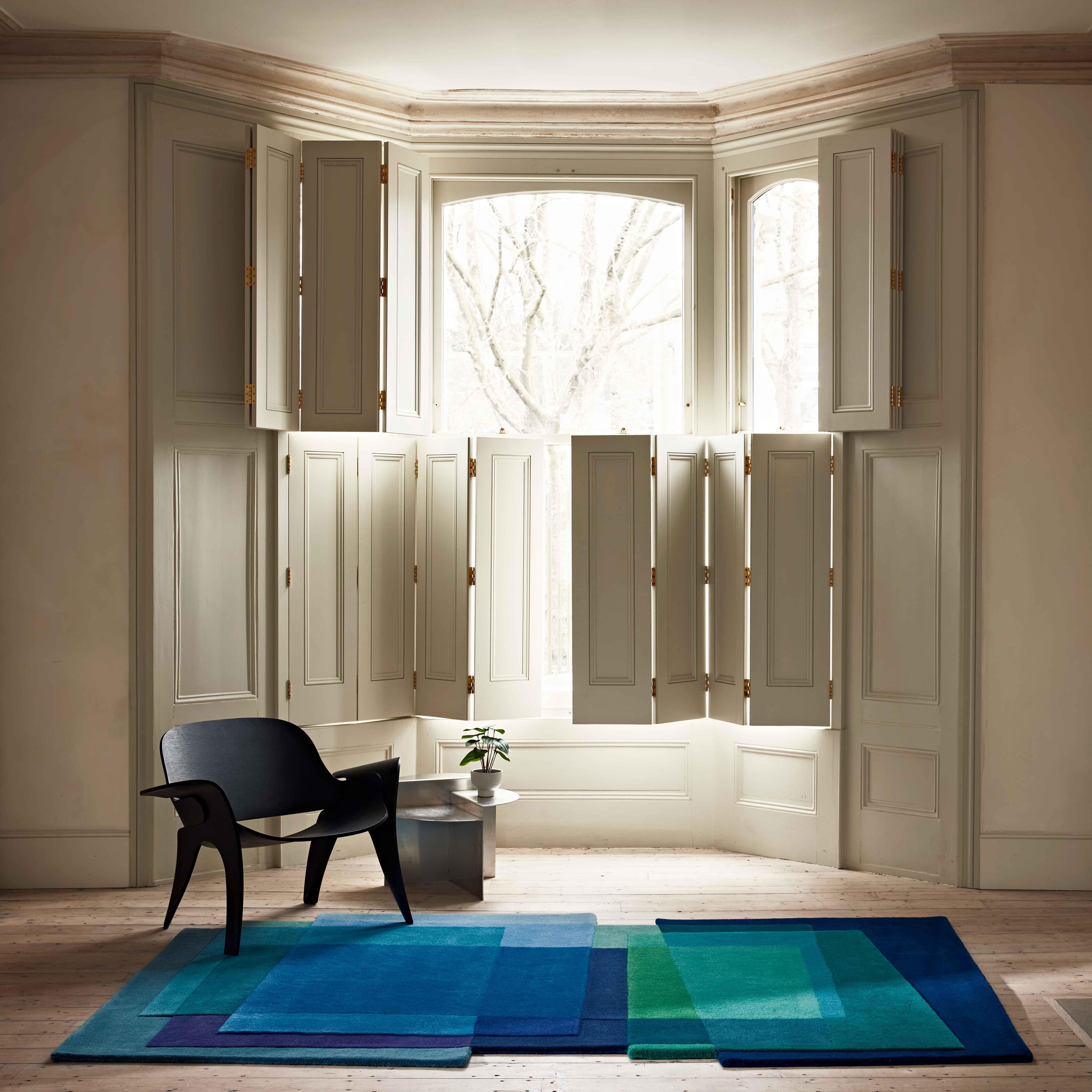 After Albers Cornflower is a geometric blue rug with a highly contemporary feel. The abstract and highly imaginative design of the rug plays with planes of bold colour overlapping and blending to create a complex, yet harmonious mix of hues. The