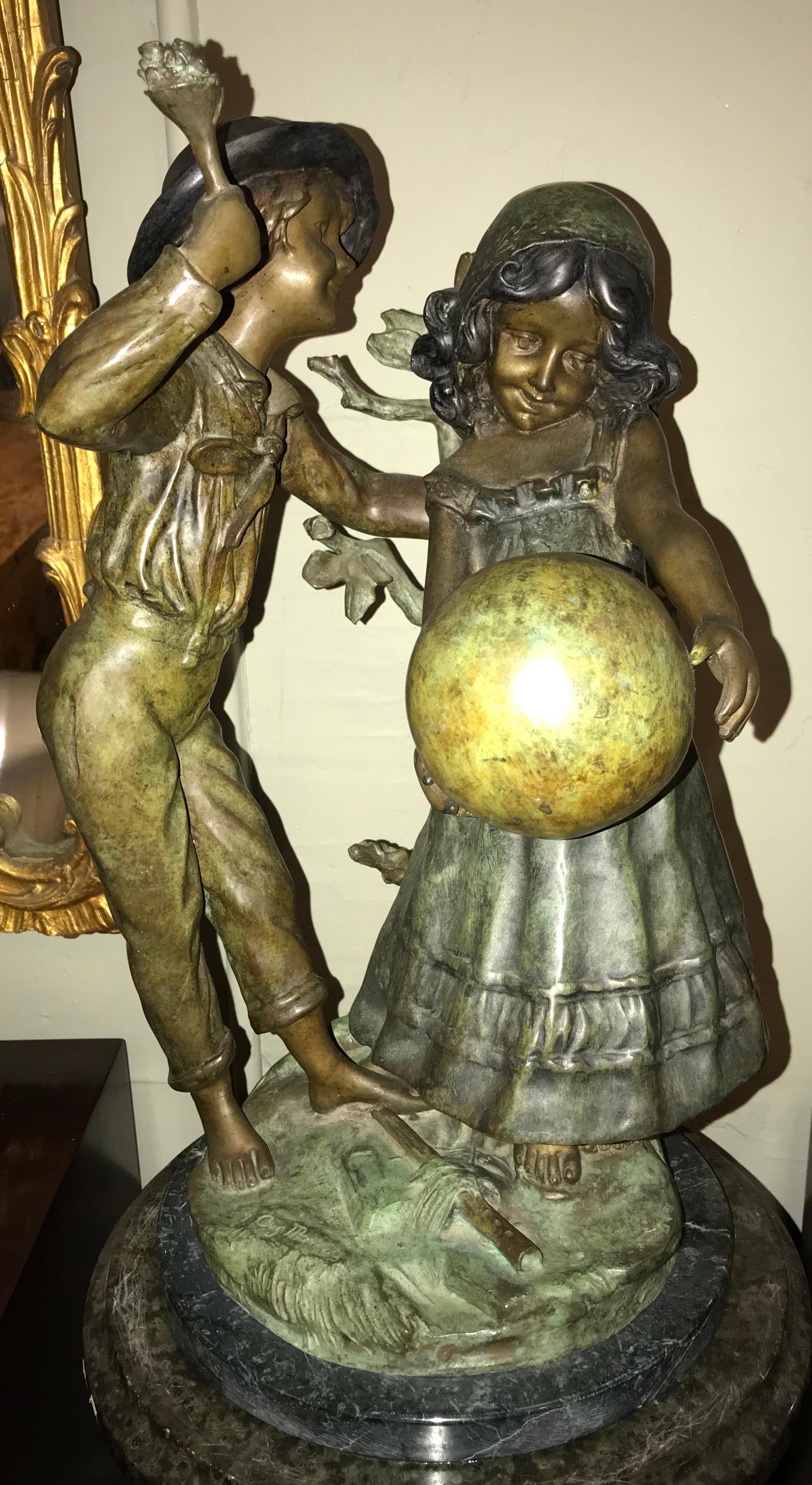 A bronze statue of a boy and girl playing with a ball signed. This finely cast bronze has a wonderful patina and the subject matter is simply breathtaking. This fine piece after August Moreau shows a brother and sister playfully enjoying their time