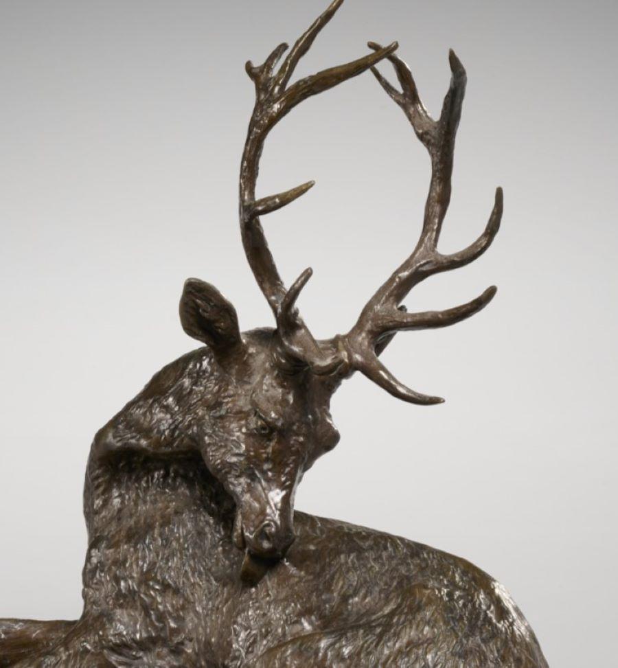 After Christophe Fratin (French 1801-1864), a majestic 12 point stag in brown patinated cast bronze, modeled with head turned to towards hind, inscribed 