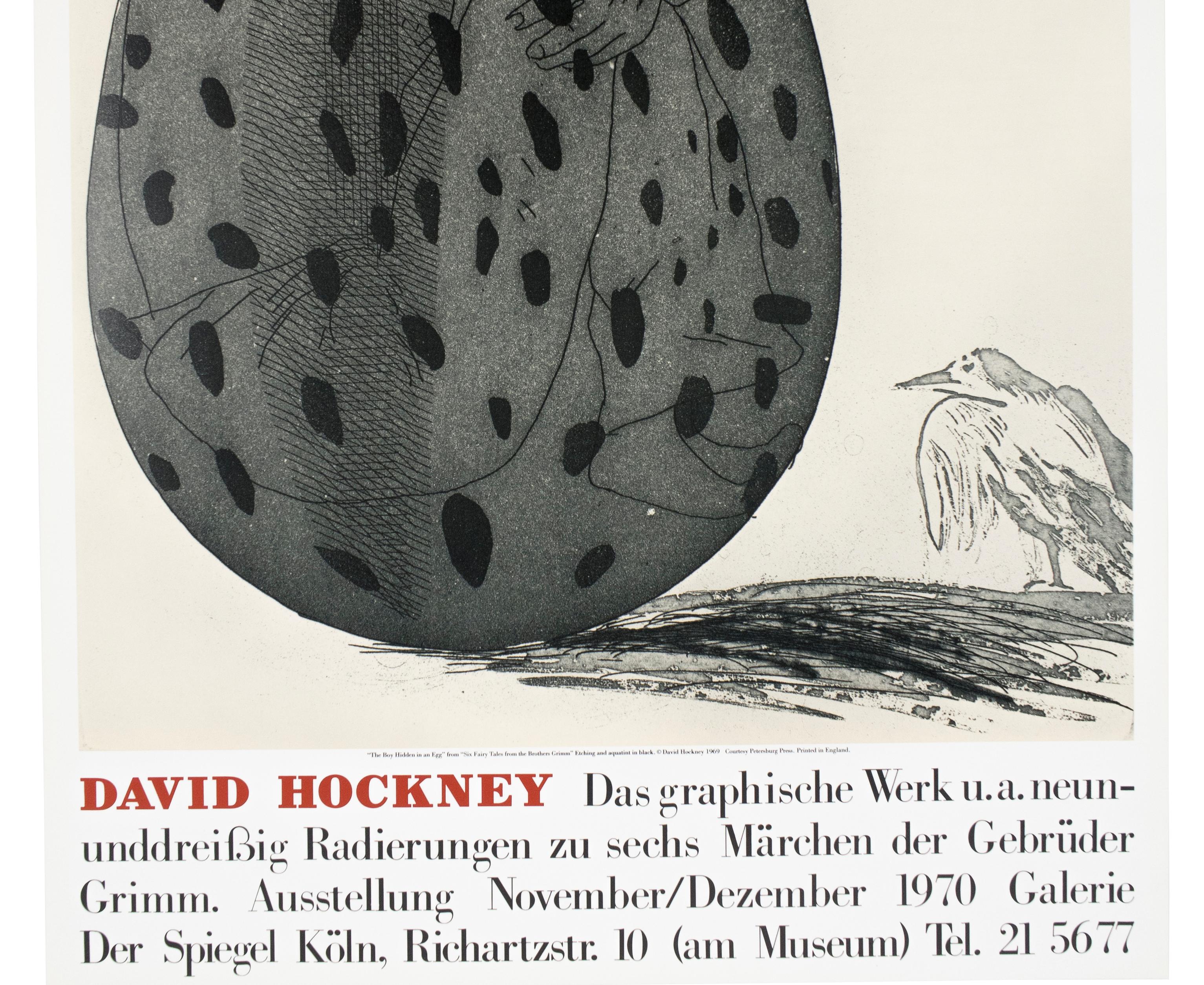 This vintage exhibition poster reproduces The Boy Hidden in an Egg by David Hockney from his Six Fairy Tales from the Brothers Grimm, 1969.  A shirtless young man curls up inside a dark grey speckled egg, as a small bird looks on. The poster was
