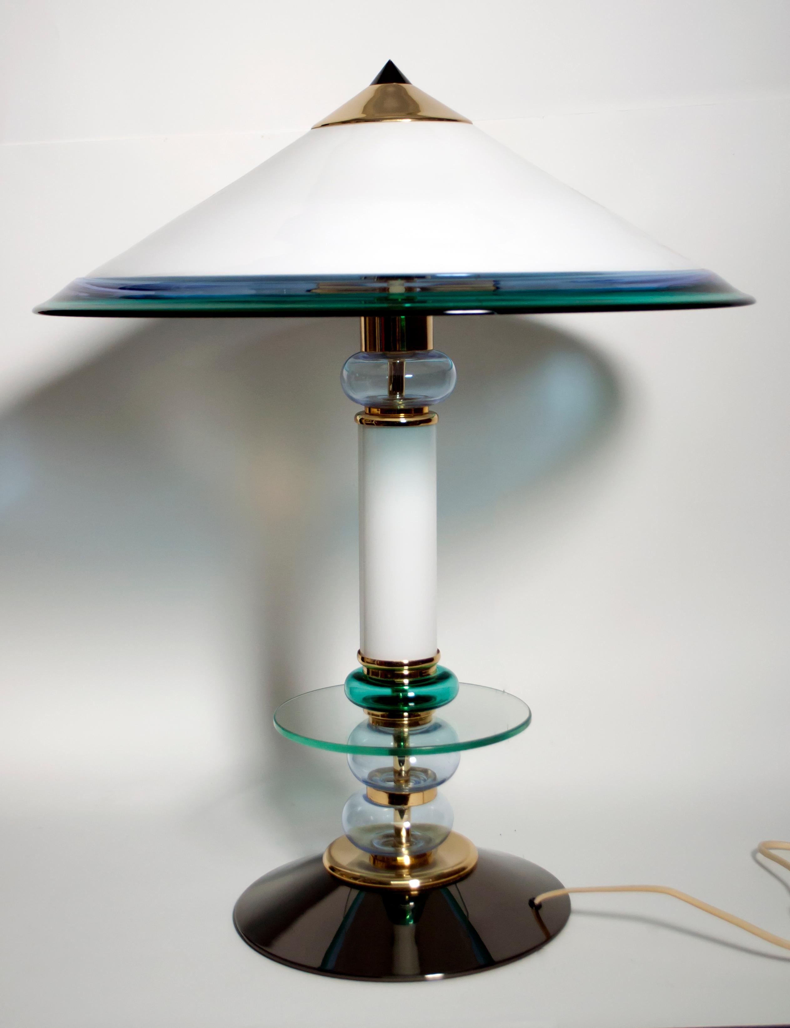 This Murano glass lamp, produced in the 1980s, has a gun metal base and brass parts. It was designed in the style of Ettore Sottsass.